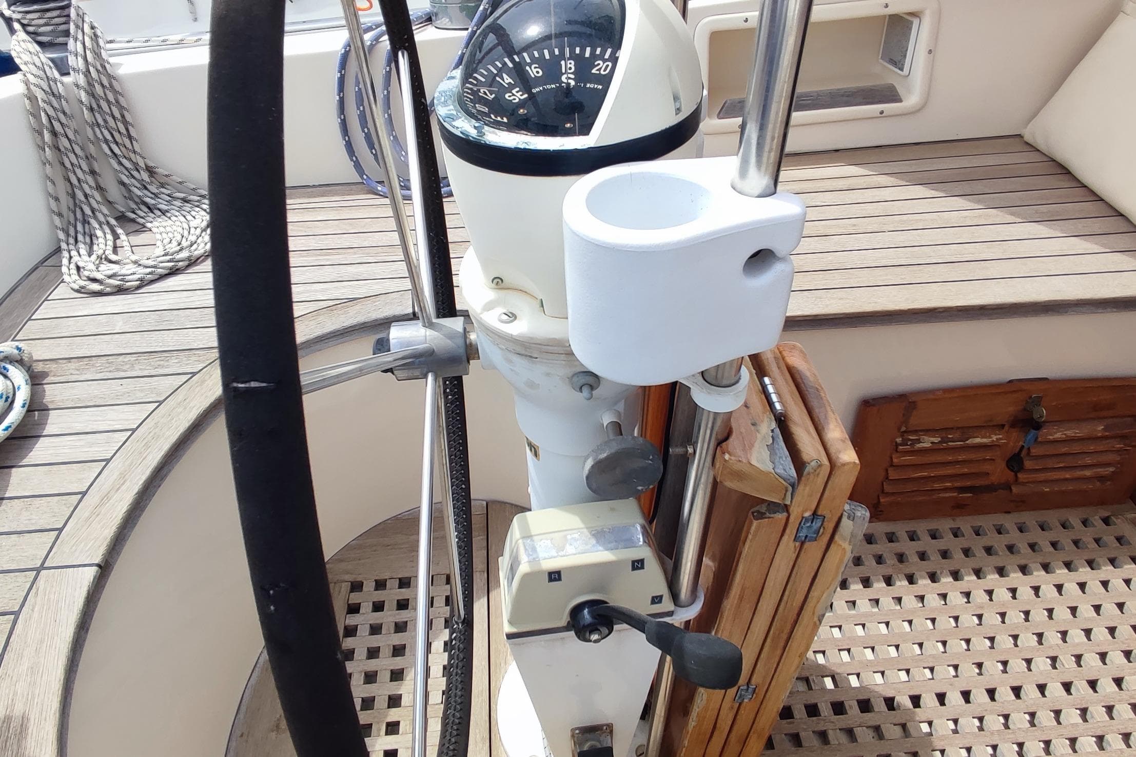 Cockpit of 1982 Hallberg-Rassy 352 sailboat with steering wheel and compass.