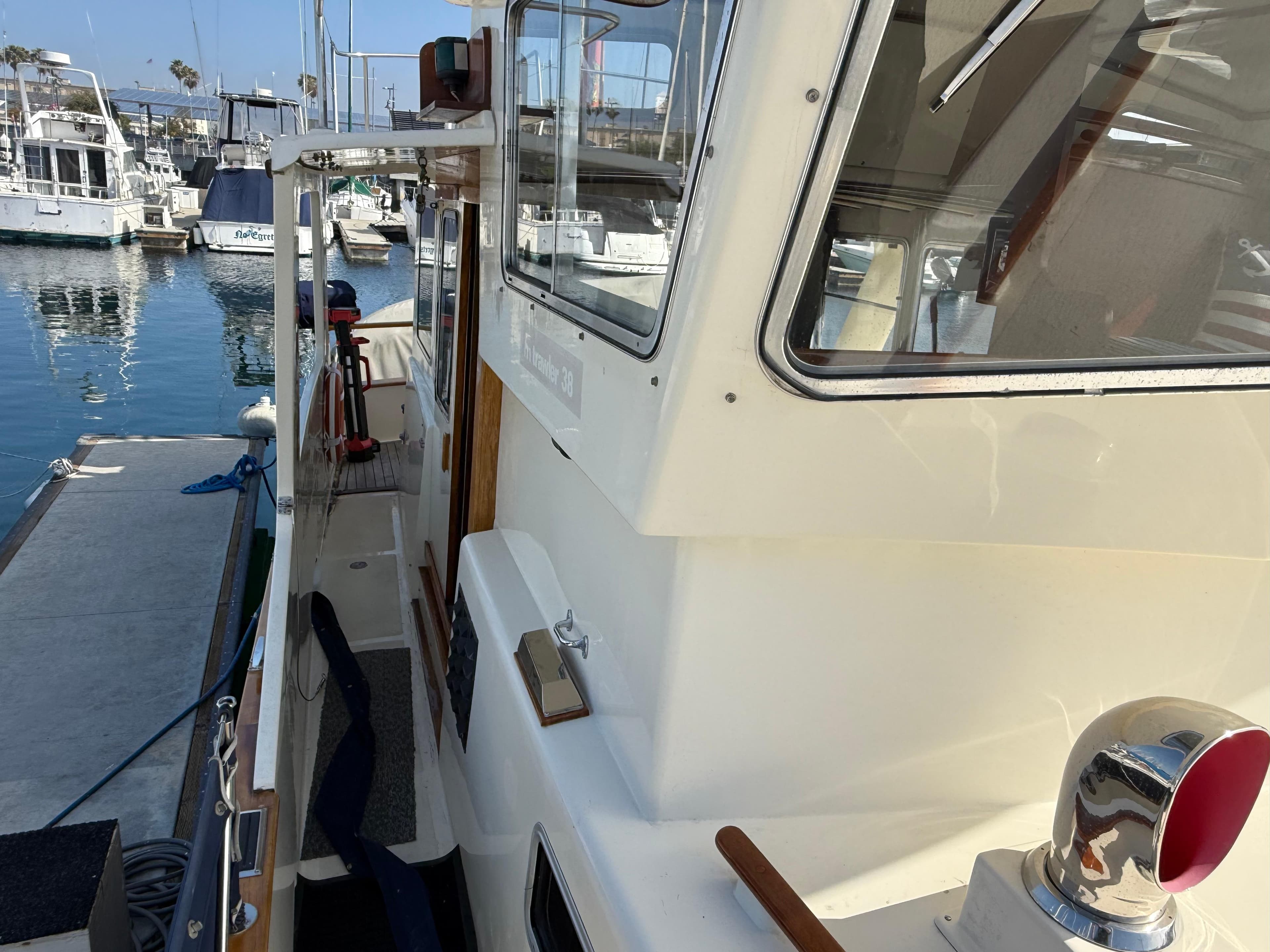 1978 Fisher 38 Trawler docked at marina, showcasing side deck and cabin details.