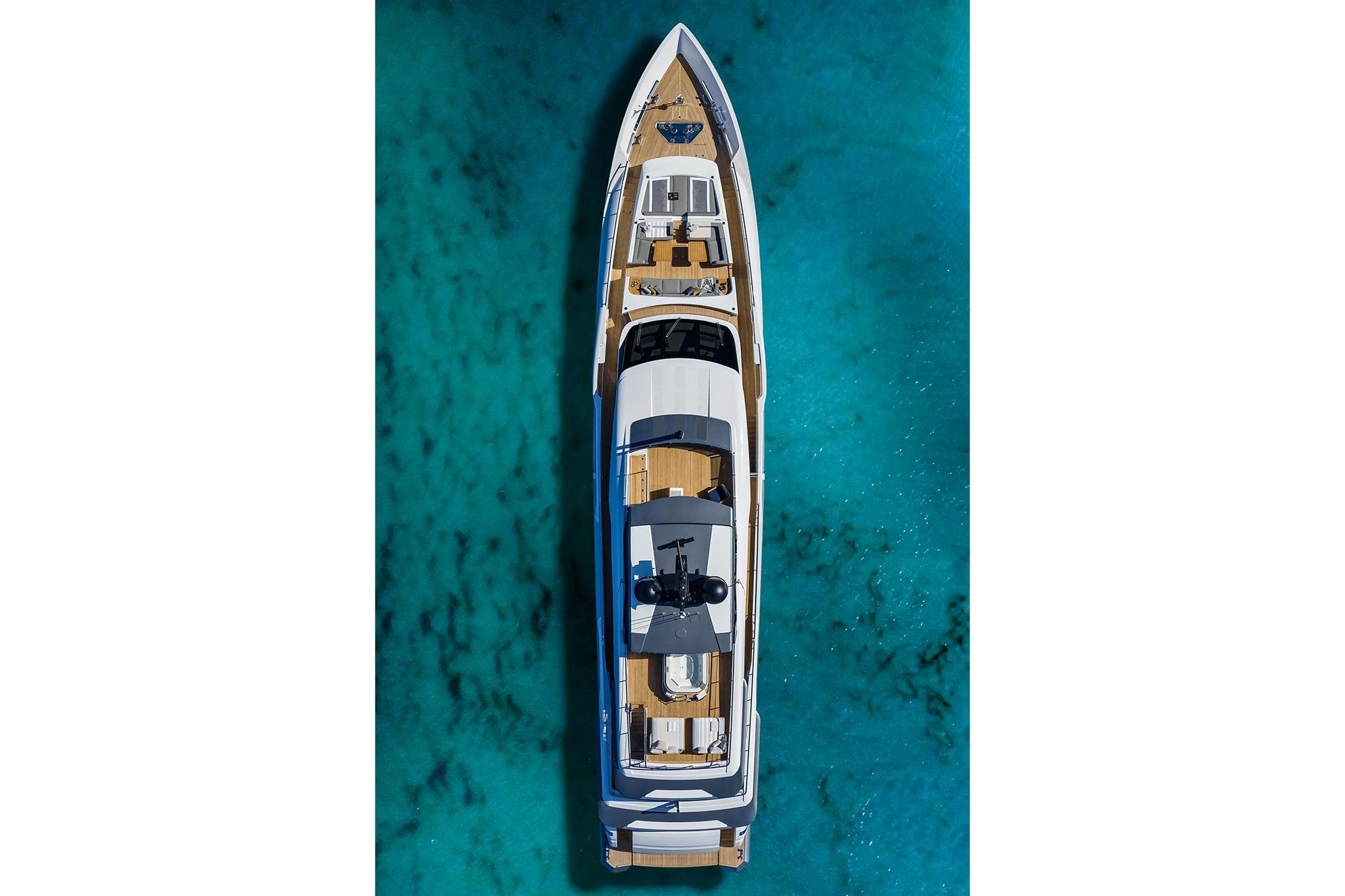 Aerial view of 2022 Custom Line CL 140 yacht on turquoise water.