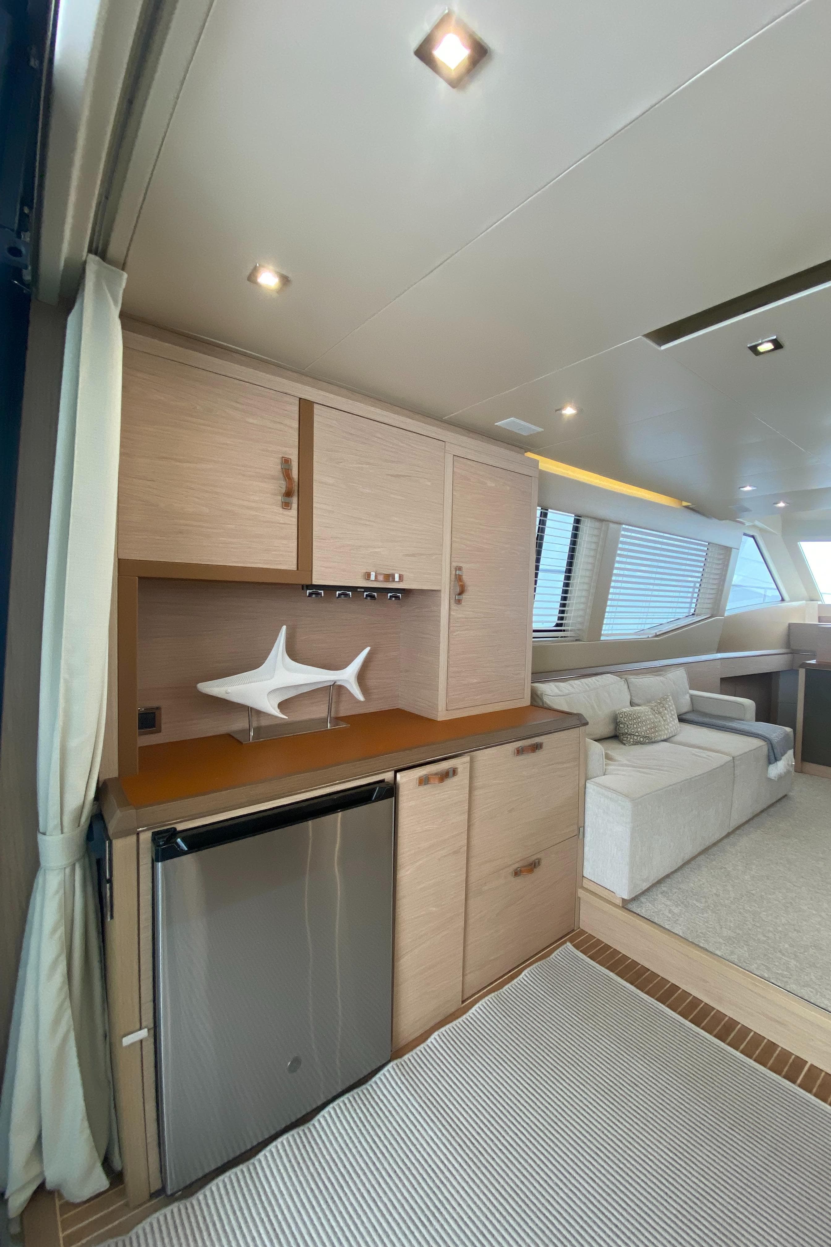Interior of 2017 Beneteau Monte Carlo MC6 yacht, featuring modern cabinetry and seating area.