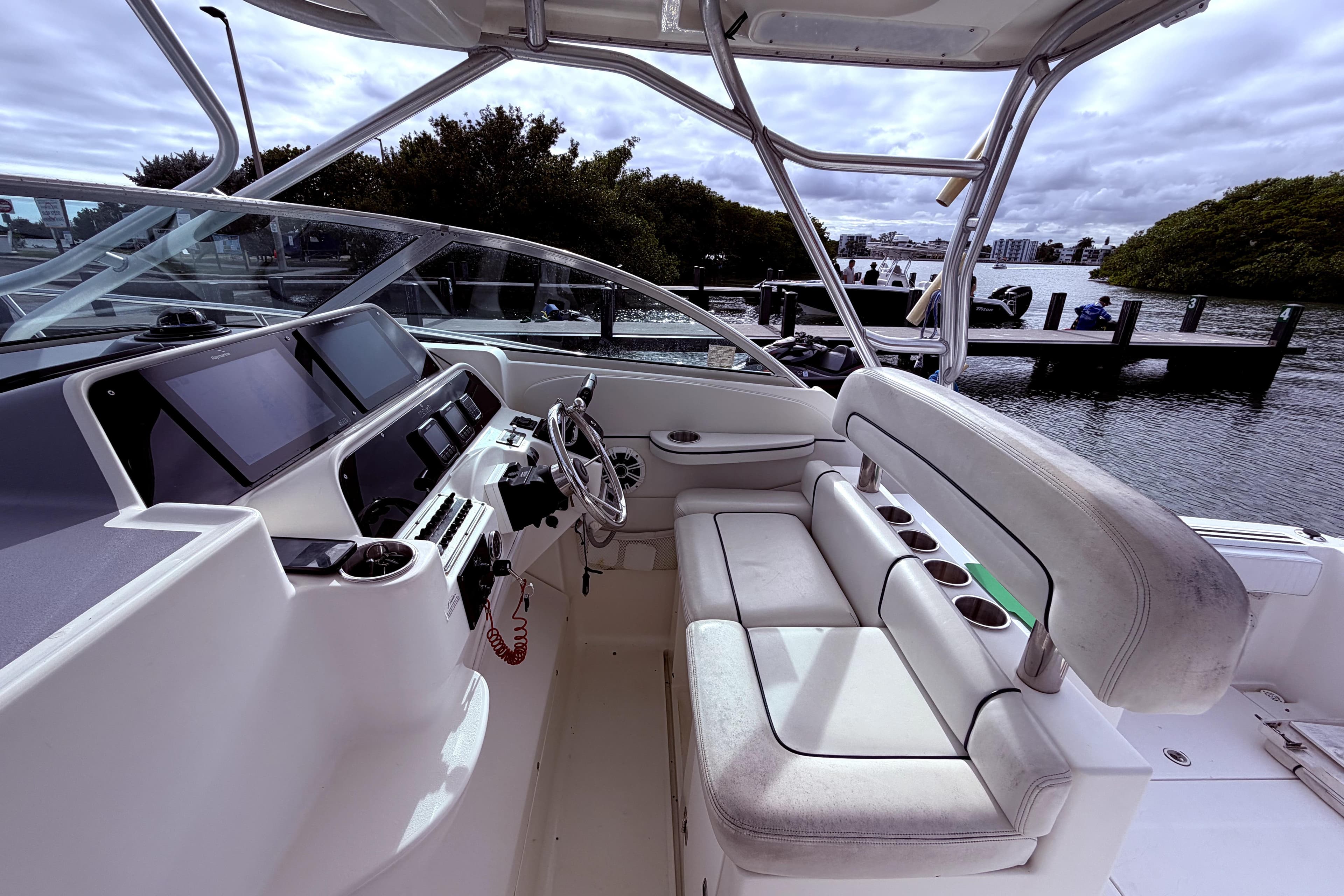 2001 Wellcraft 290 Coastal boat interior with helm, seating, and water view.