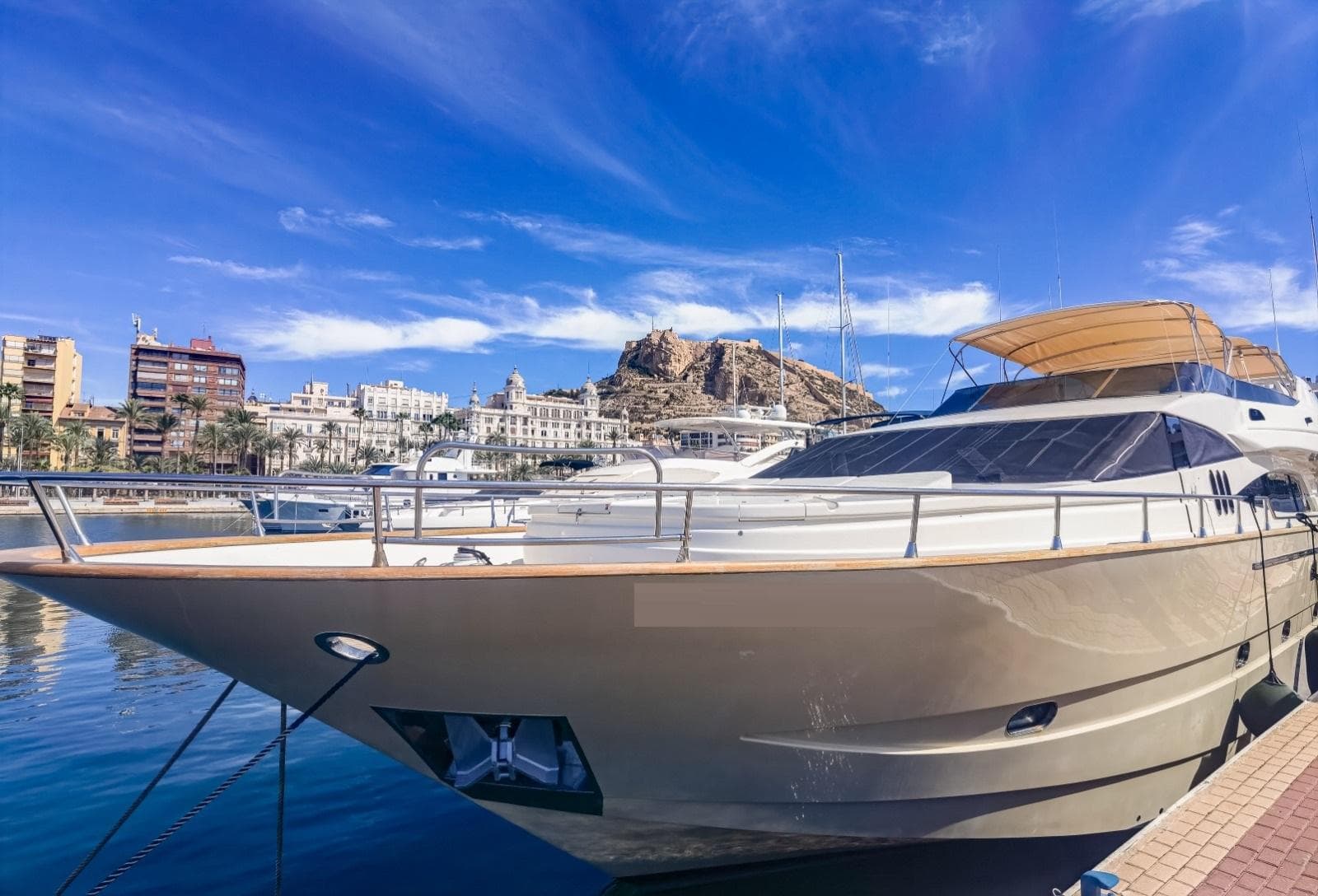 Luxury 1997 Astondoa 95 GLX yacht docked in a scenic marina.