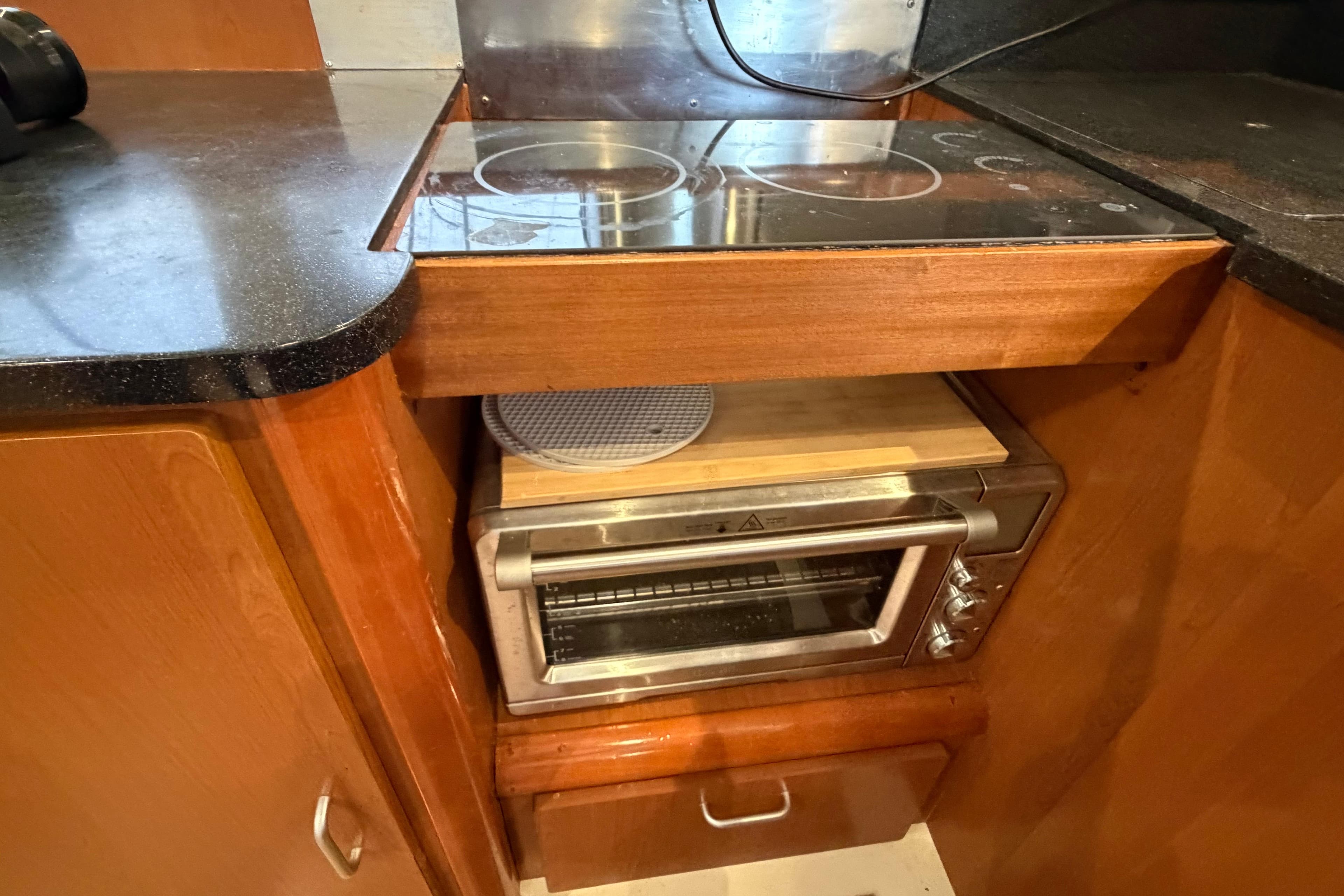 Compact kitchen area in a 2007 Leopard 46 yacht with stove and toaster oven.