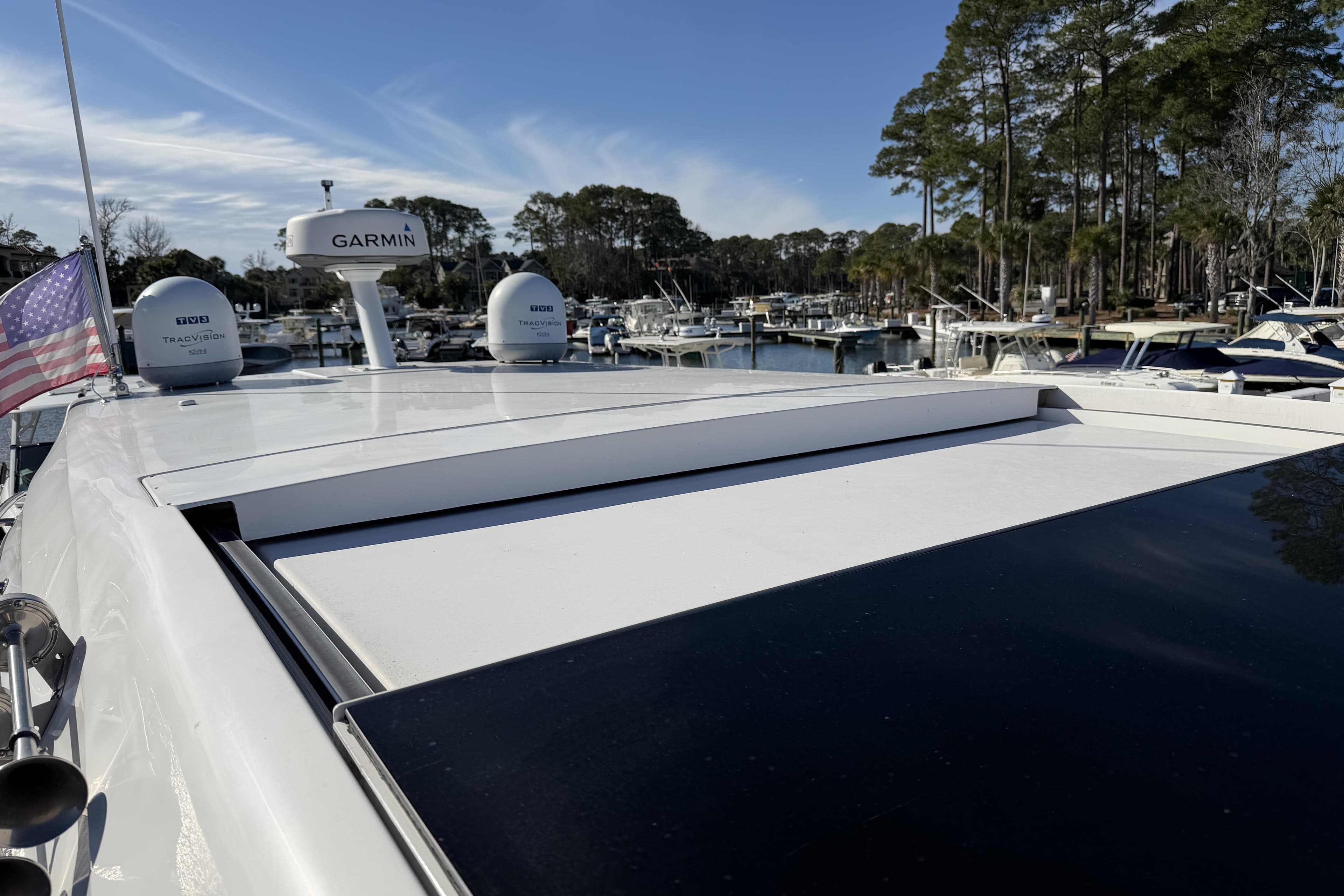 2019 Regal 42 Grande Coupe yacht with Garmin radar, docked in a marina.