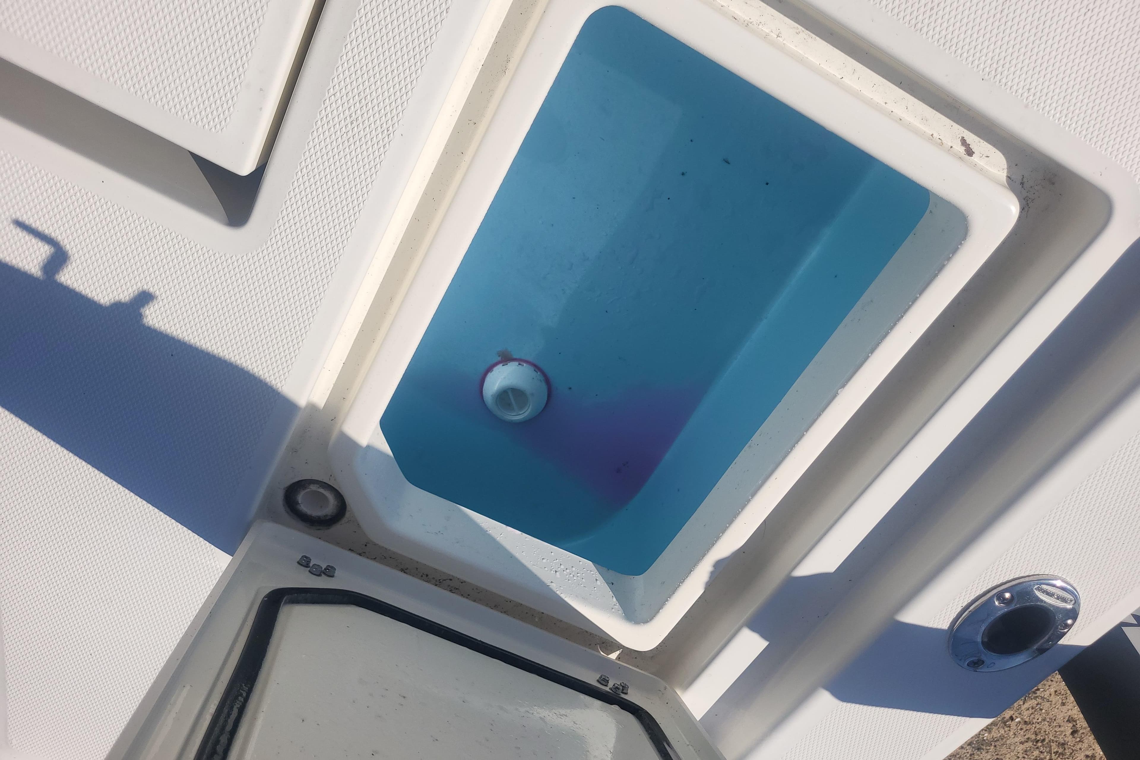 Livewell compartment on a 2024 Pathfinder 2200 TRS boat, featuring a blue interior.