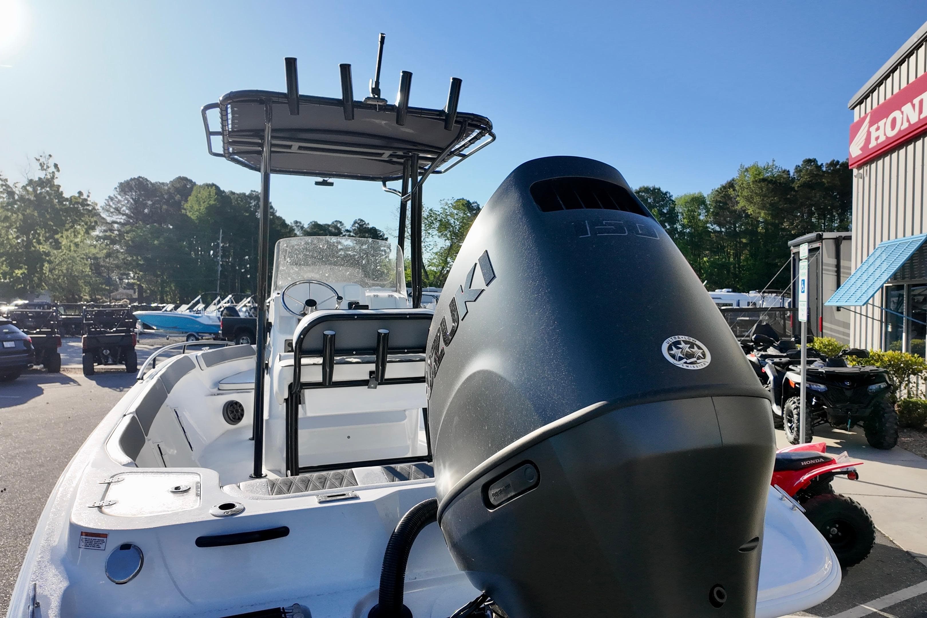 2026 ALK2 Powerboats 23 CRX with Suzuki outboard motor in dealership lot.