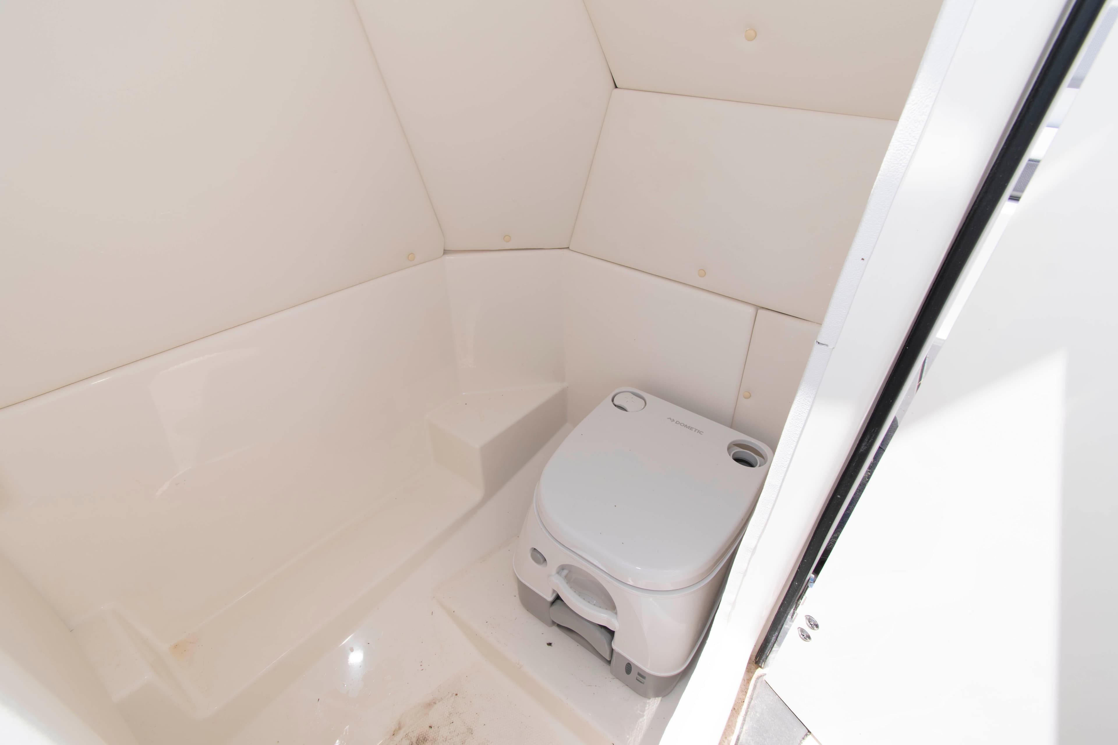 2023 Bayliner DX 2200 boat interior with compact marine toilet.