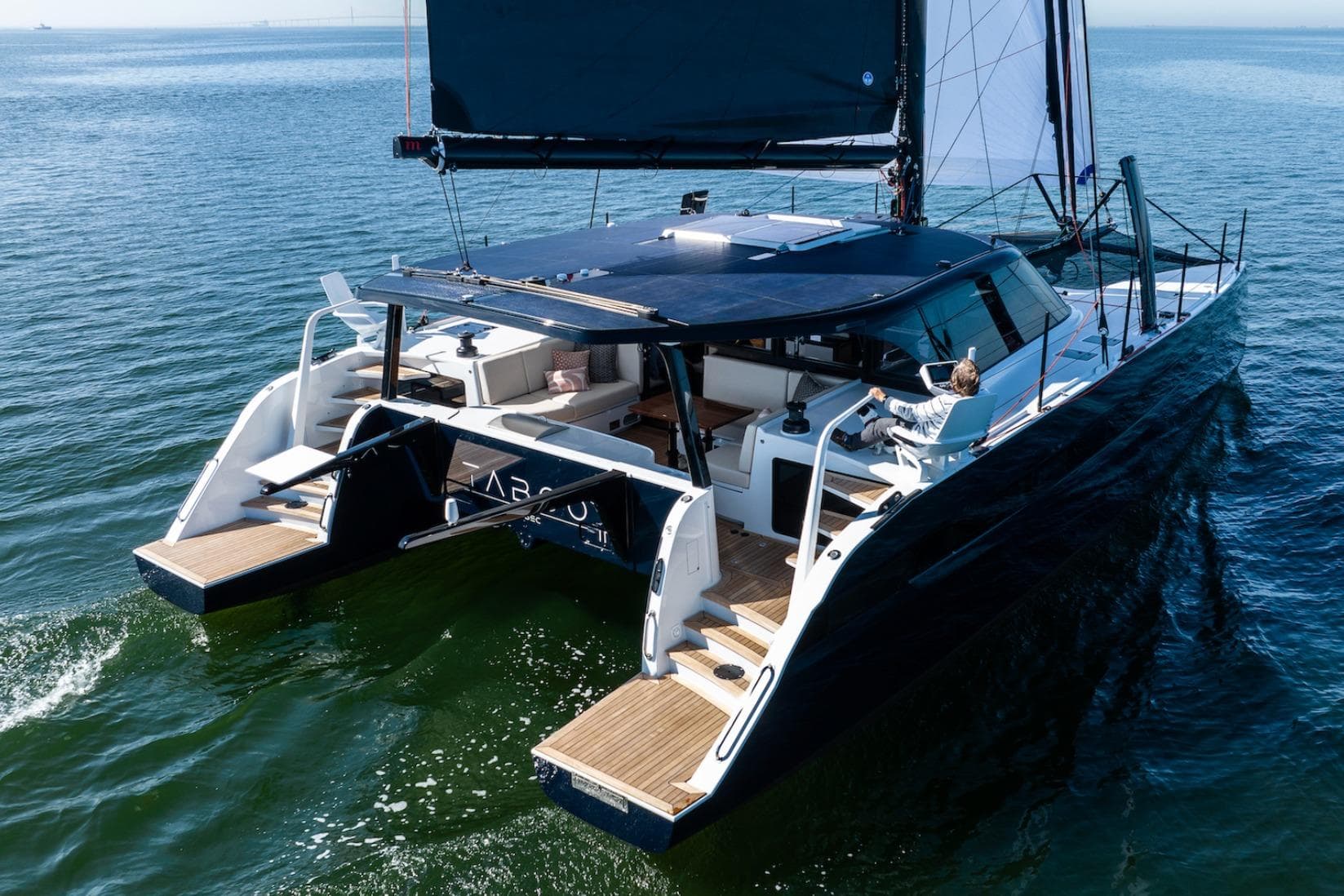 2026 HH Catamarans HH52 sailing on open water, featuring sleek design and spacious deck.