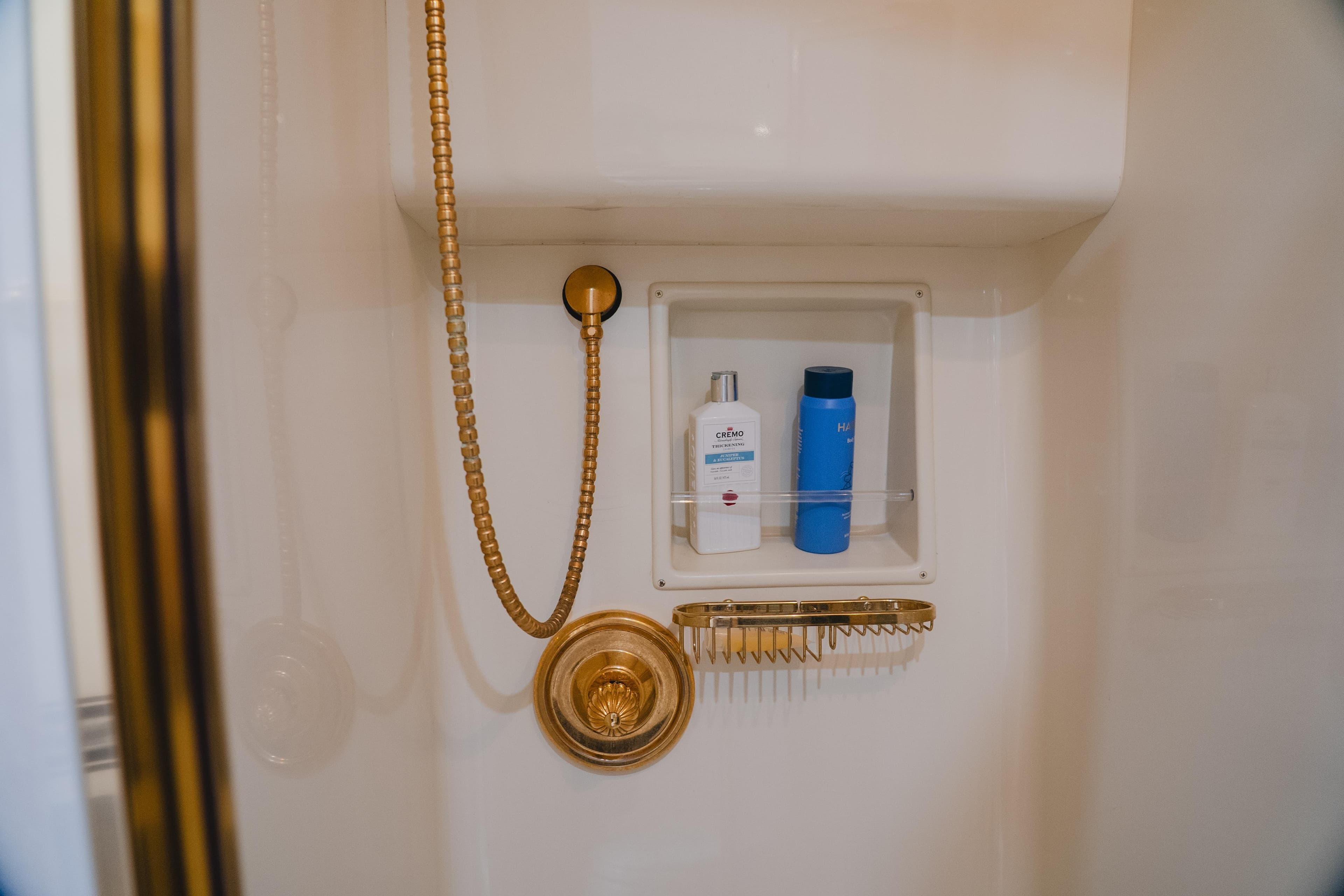 Luxury shower with gold fixtures on 1999 Viking 58 Convertible yacht.