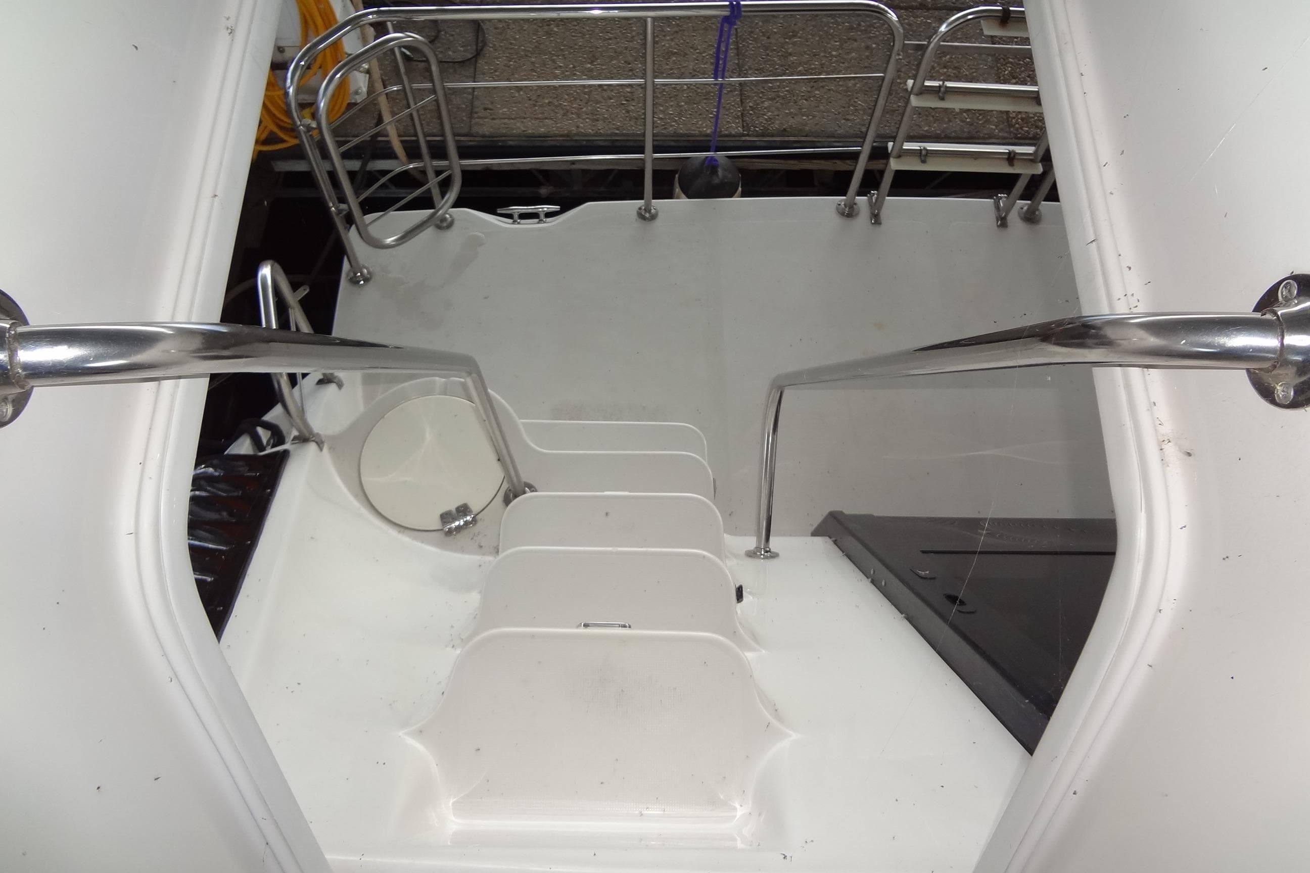 Staircase on 2008 Bluewater 5200 Signature Edition yacht with stainless steel railings.