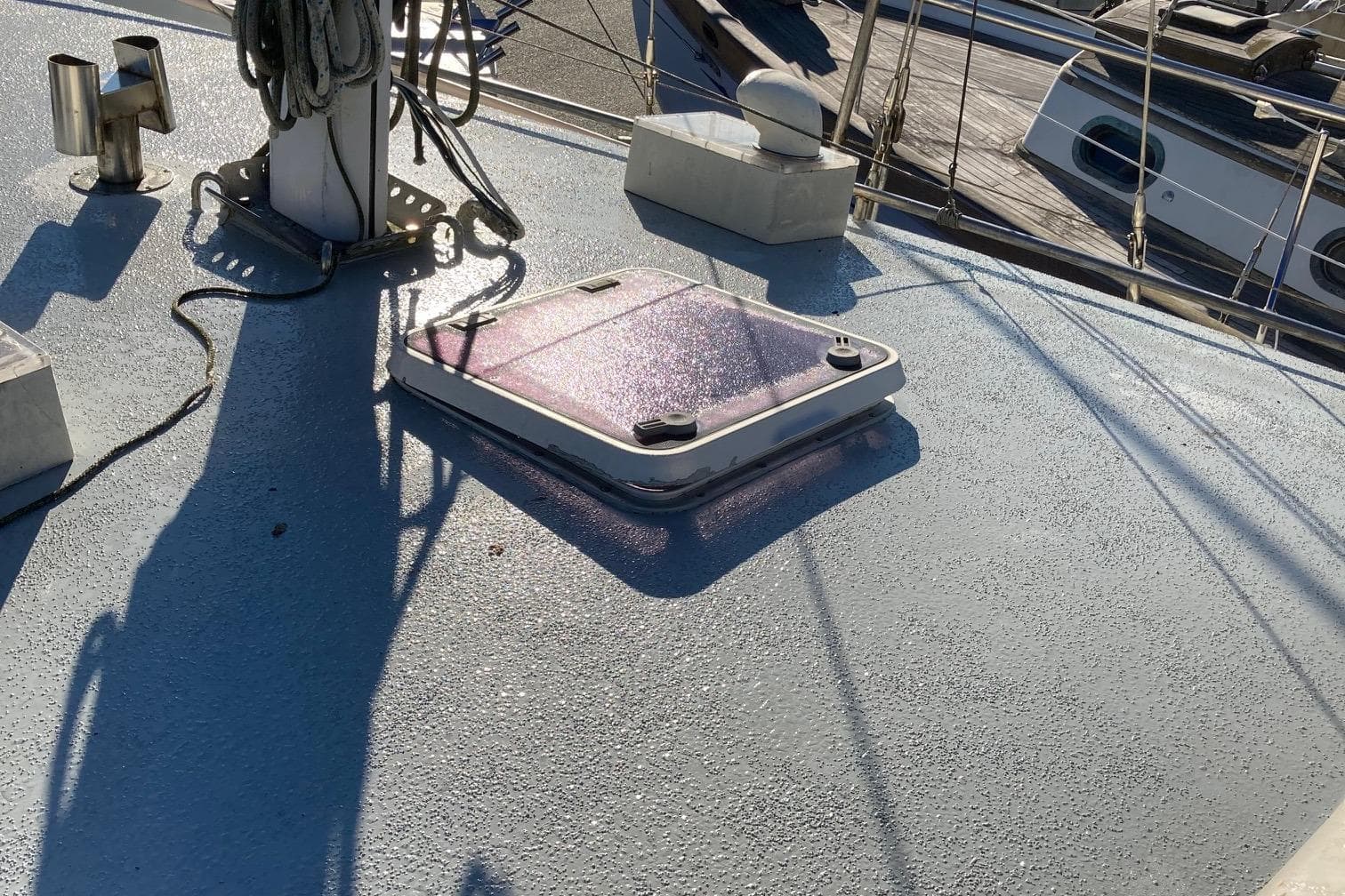 Deck of 1991 Bruce Roberts Pilothouse sloop with hatch and rigging details.