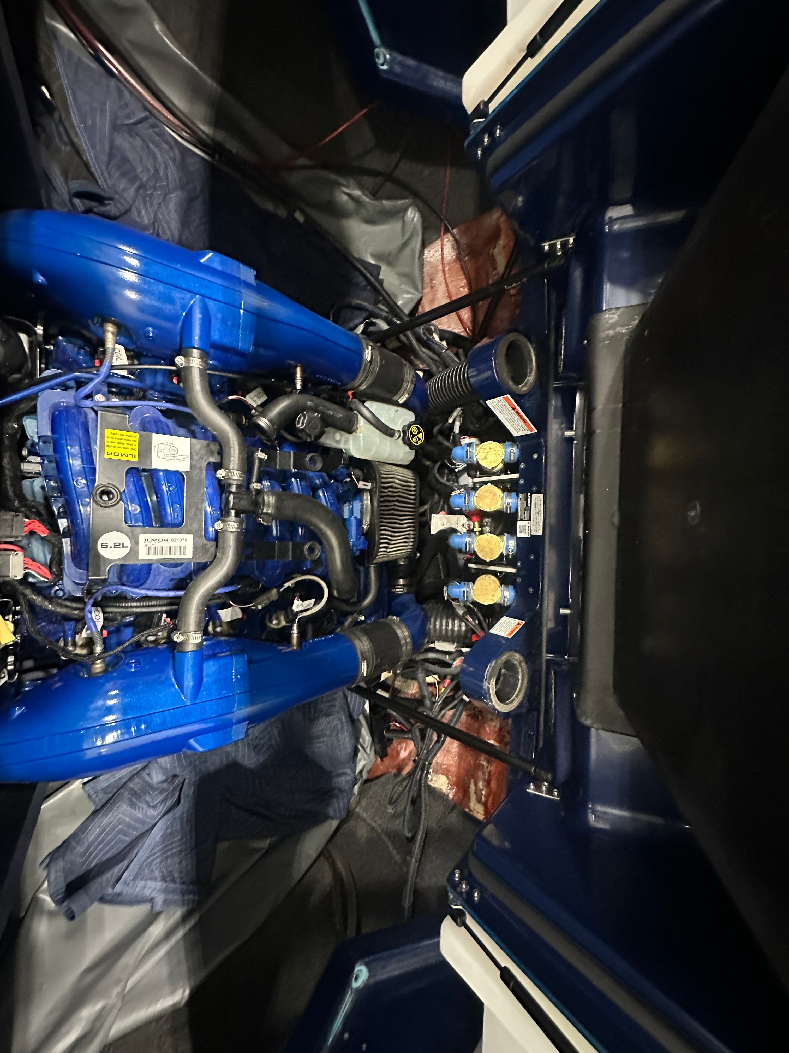 2019 MasterCraft X24 engine compartment with blue components and detailed wiring.
