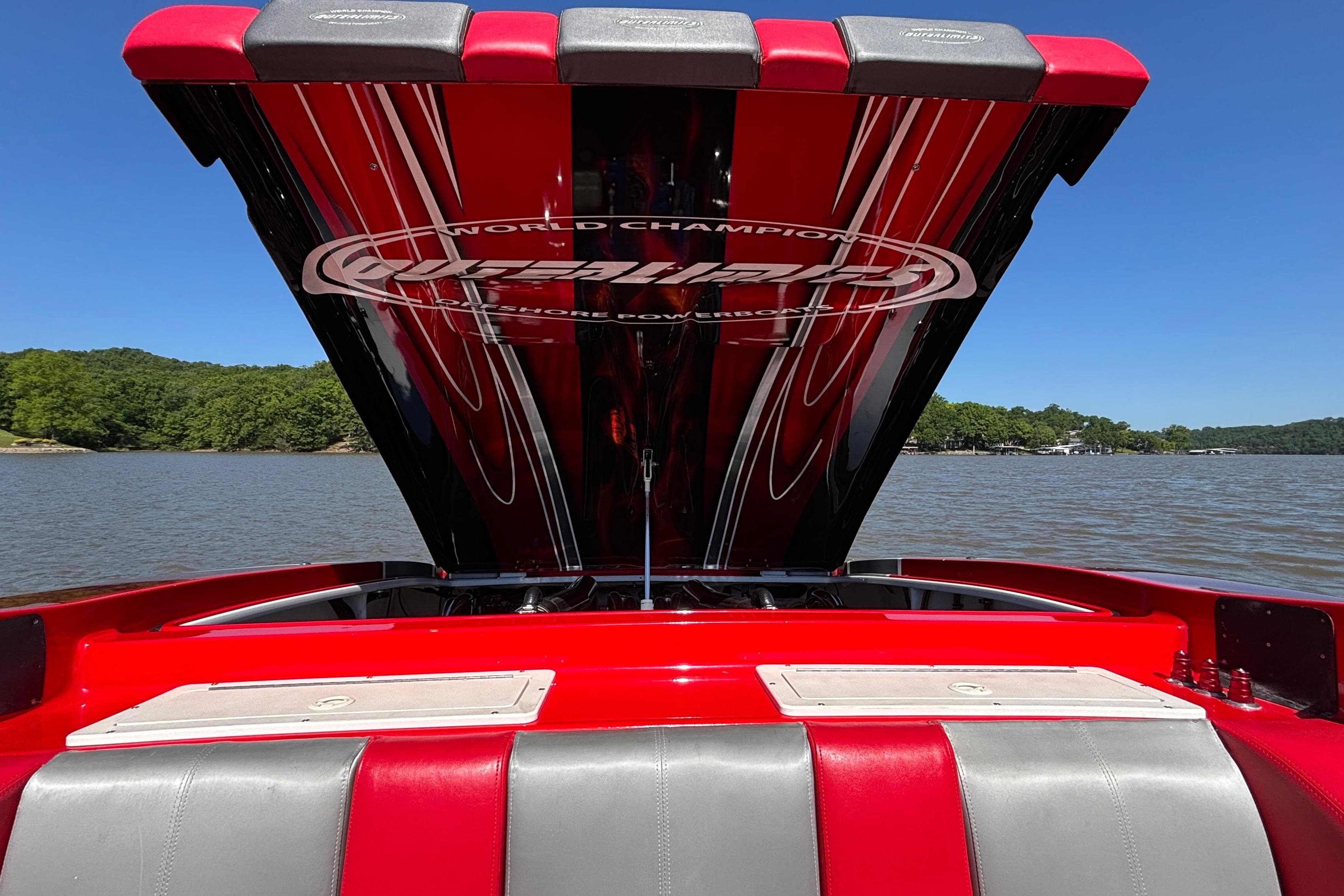 2004 Outerlimits 42 Legacy boat with open engine hatch on a sunny lake.