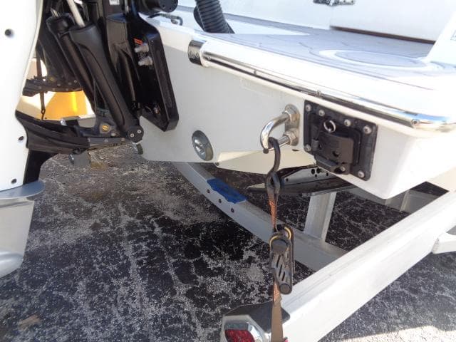 2022 Contender 32 ST boat on trailer, showing engine mount and tie-down strap.
