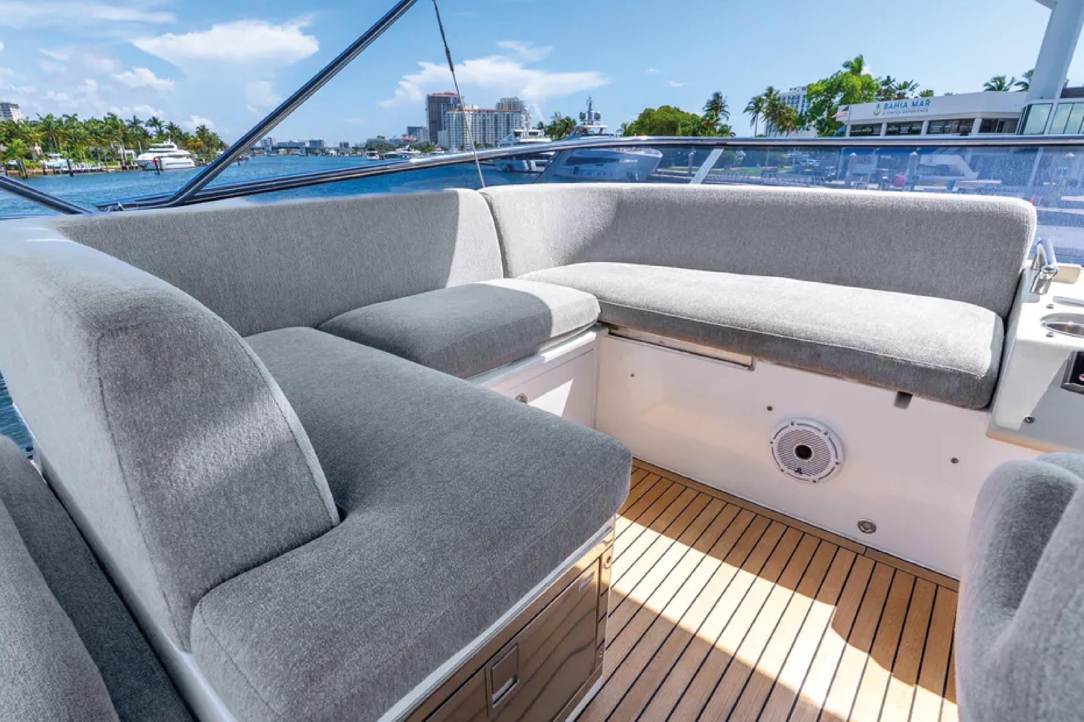 Luxurious seating area on 2019 Azimut S7 yacht with waterfront view.