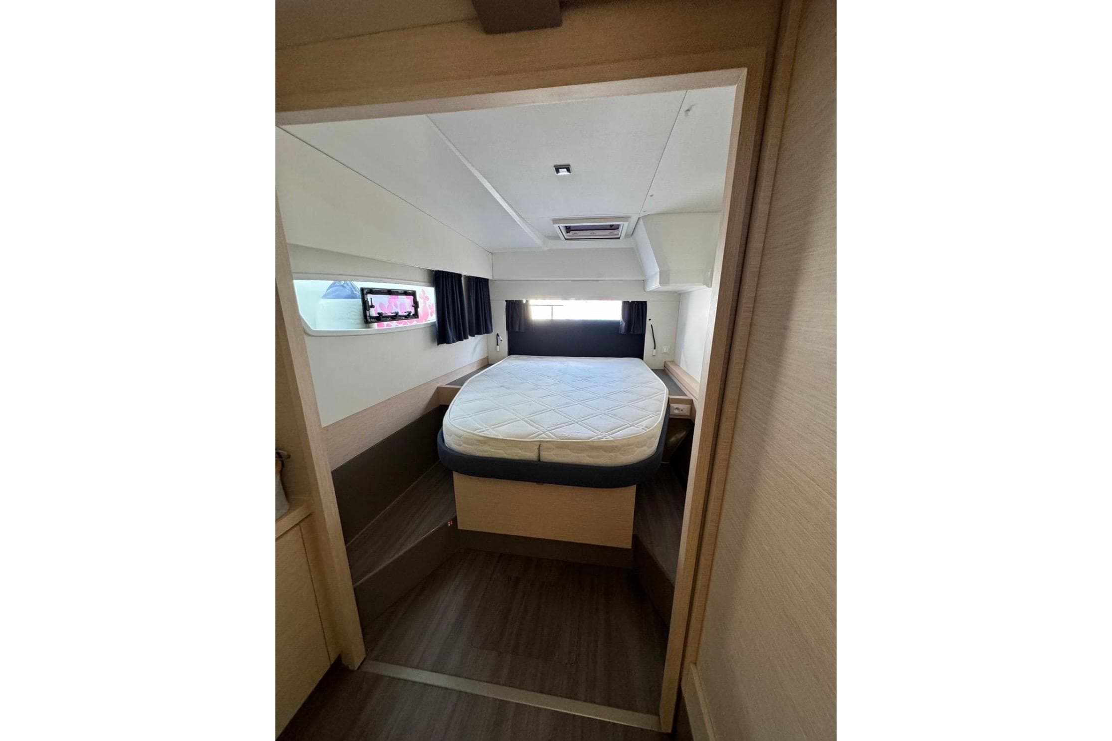 2019 Fountaine Pajot Astrea 42 Catamaran cabin with bed, window, and modern interior design.