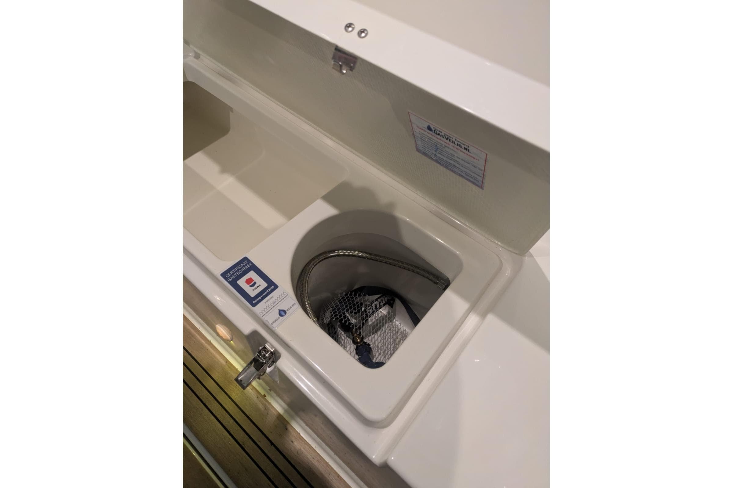 Storage compartment on 2016 Nimbus Boats 305 Coupé, featuring a secure latch and interior space.