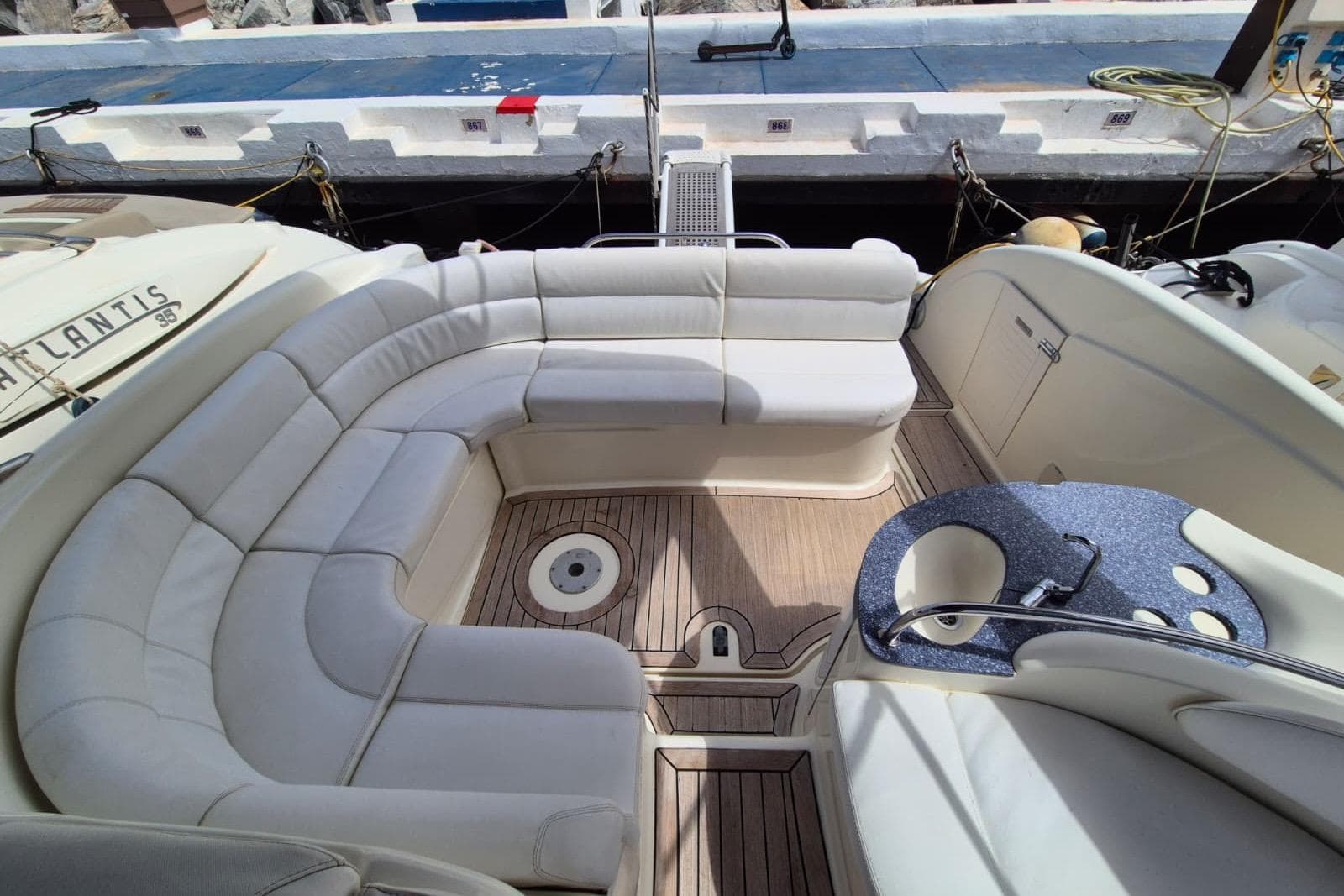 Luxurious seating area on a 2008 Atlantis 345sc yacht with elegant wood flooring.