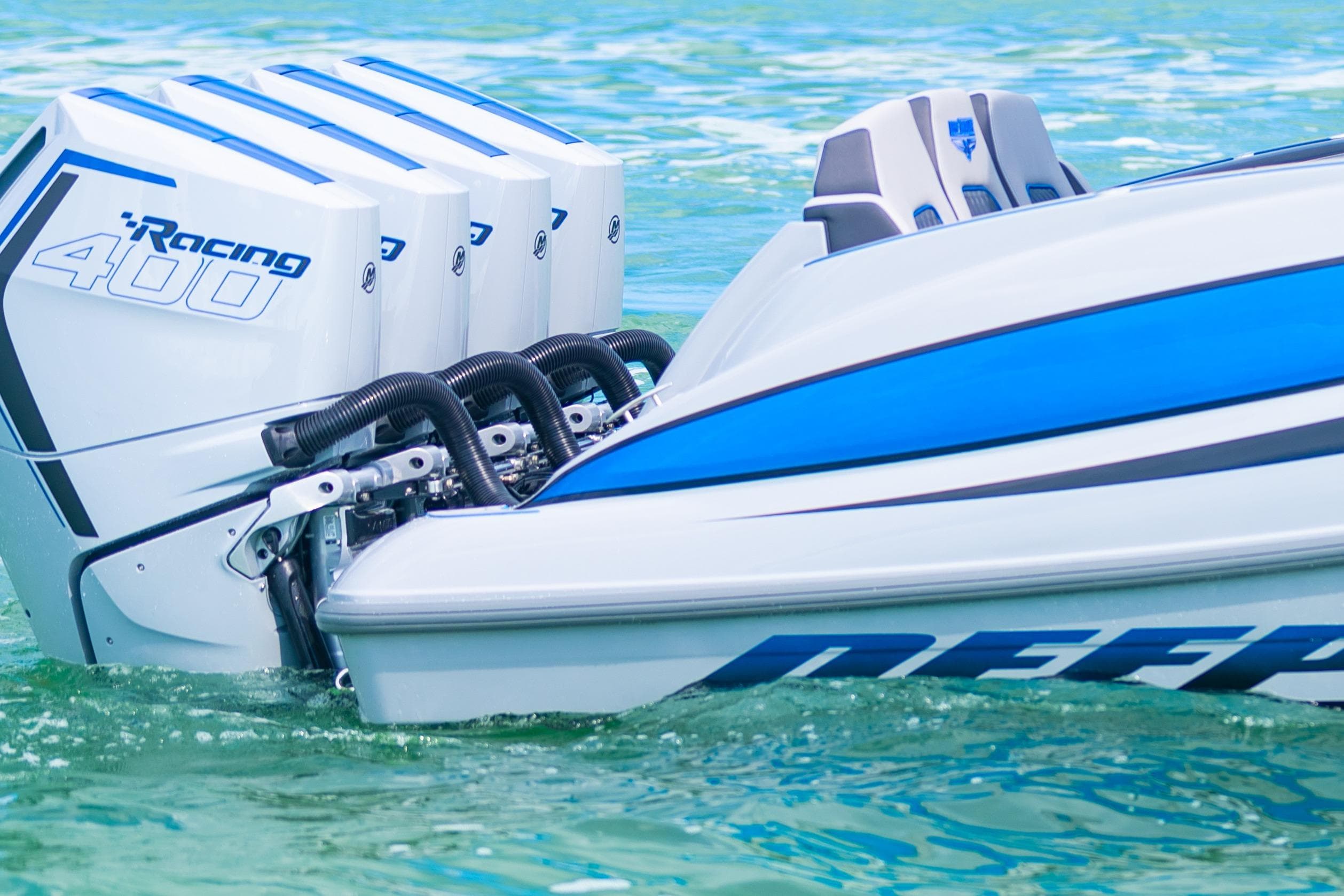 2023 Deep Impact 399 Sport boat with powerful Racing 400 engines on clear water.