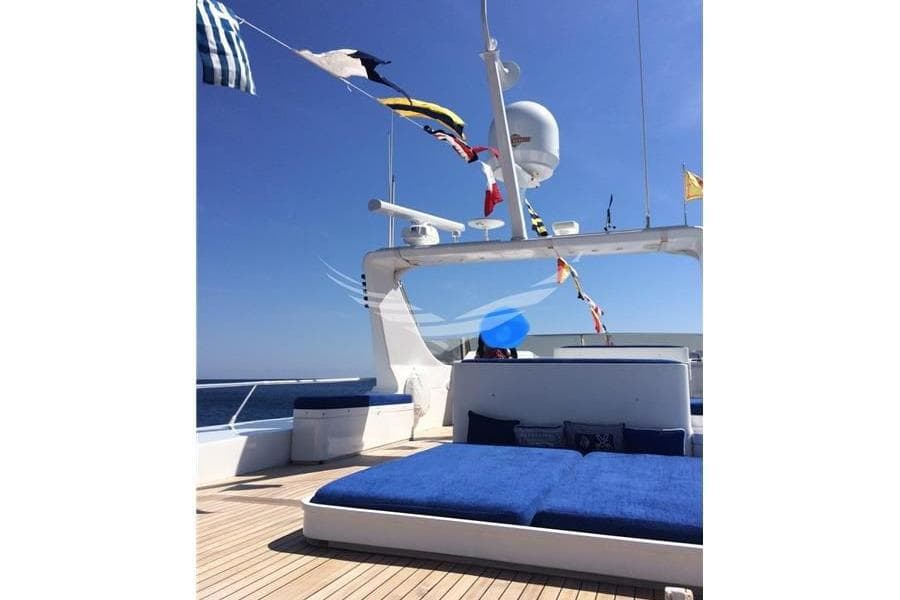 Luxurious Admiral 28 yacht deck with blue cushions and nautical flags, 1993 model.