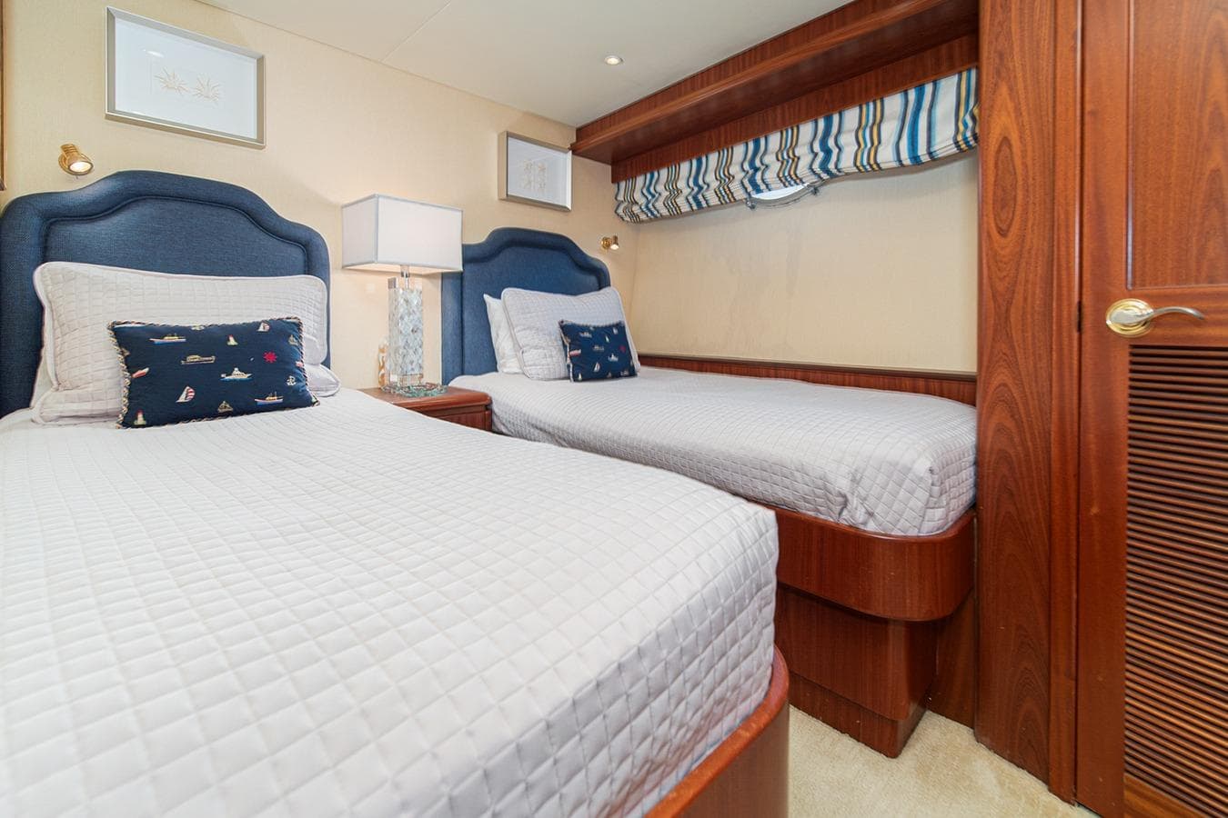 Luxurious twin bedroom in 2003 West Bay Sonship yacht with nautical decor.