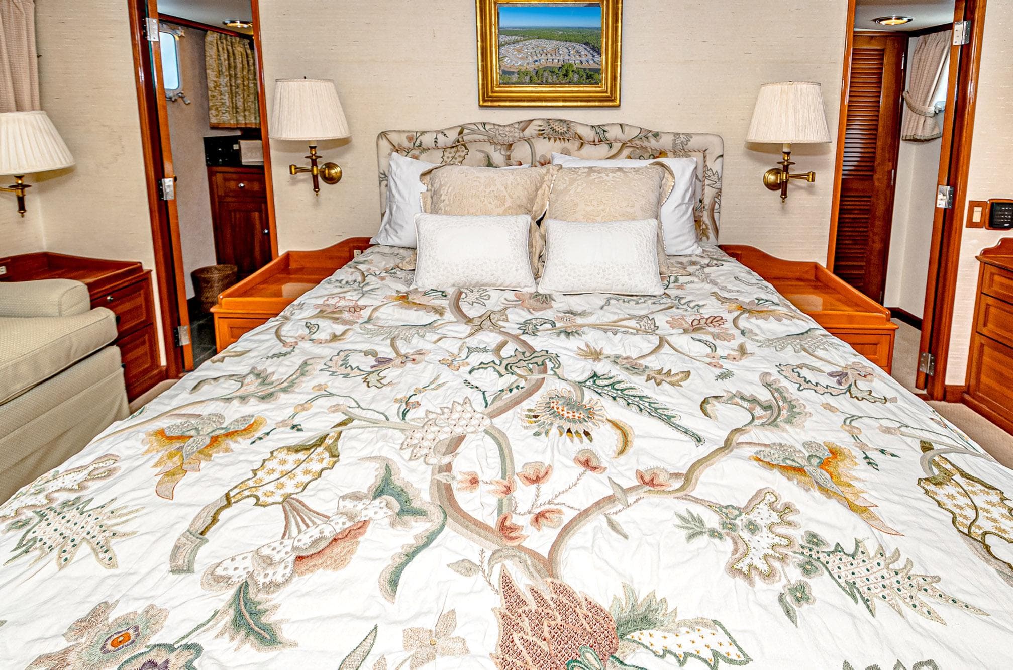 Luxurious bedroom with floral bedding on a 1984 Burger 91 yacht.