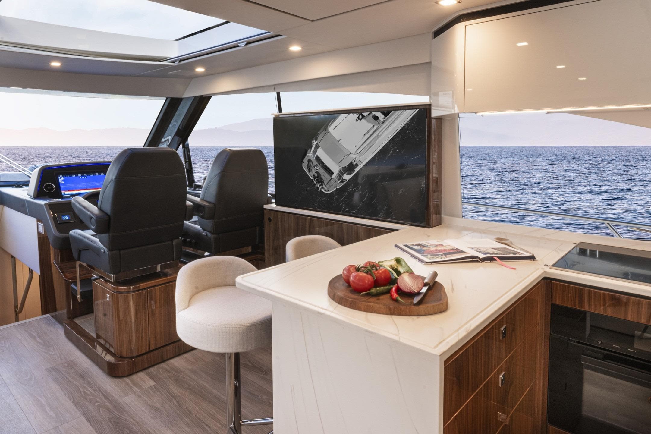 Luxurious interior of 2026 Riviera 5600 Sport Yacht Platinum Edition with ocean view.
