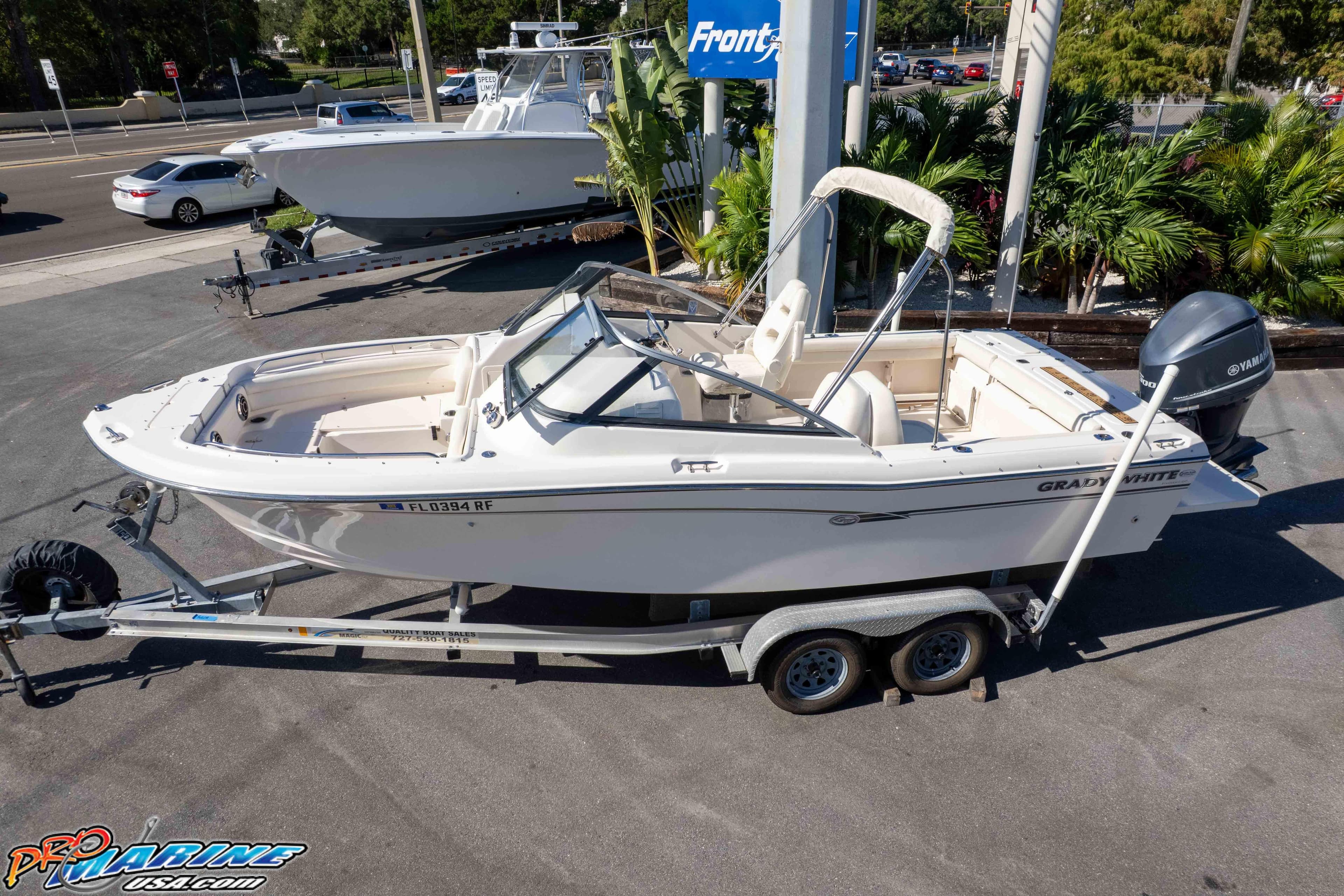 2016 Grady-White Freedom 225 boat on trailer, parked outdoors.