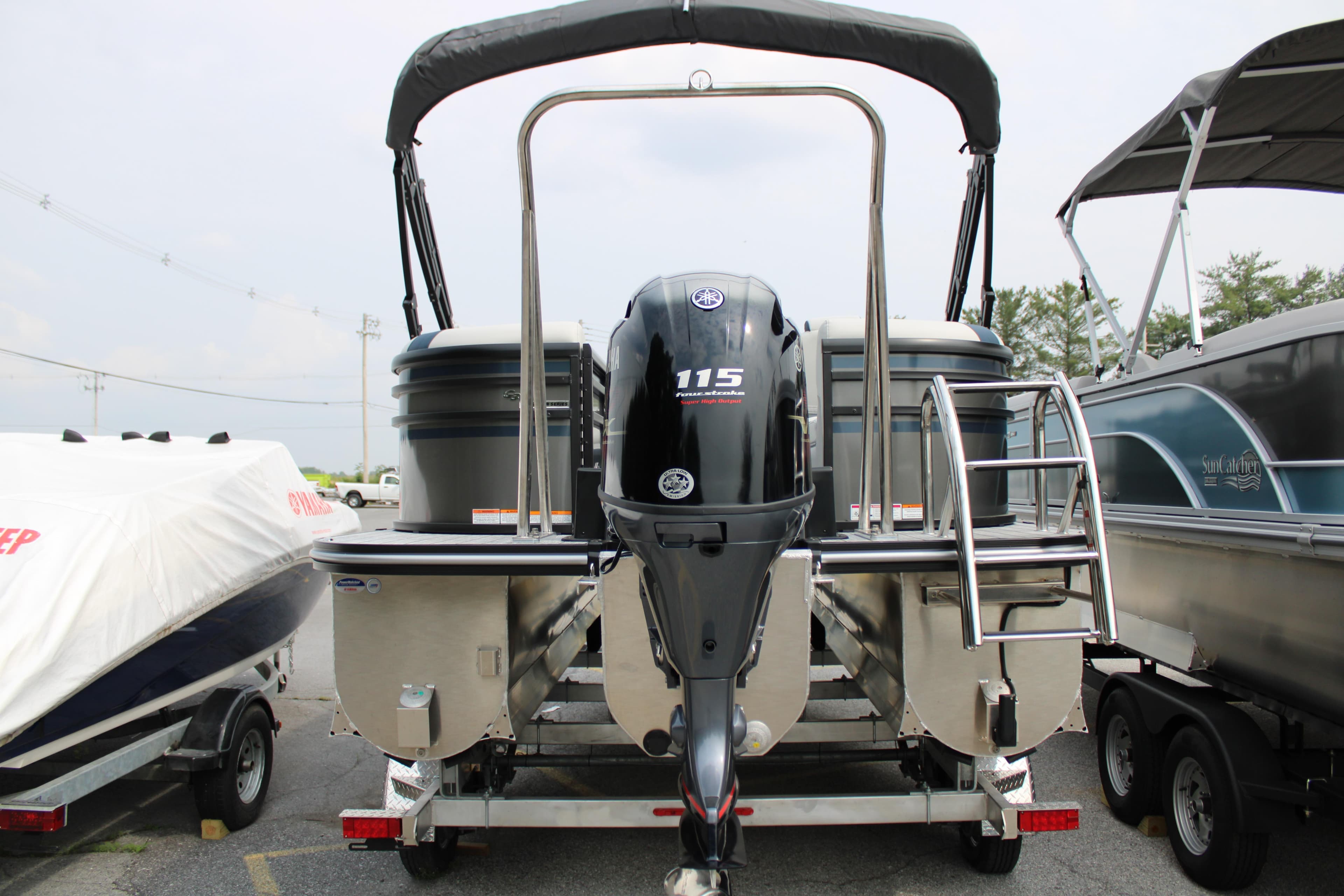 2025 SunCatcher Select 320RCX pontoon boat with Yamaha 115 engine, rear view.