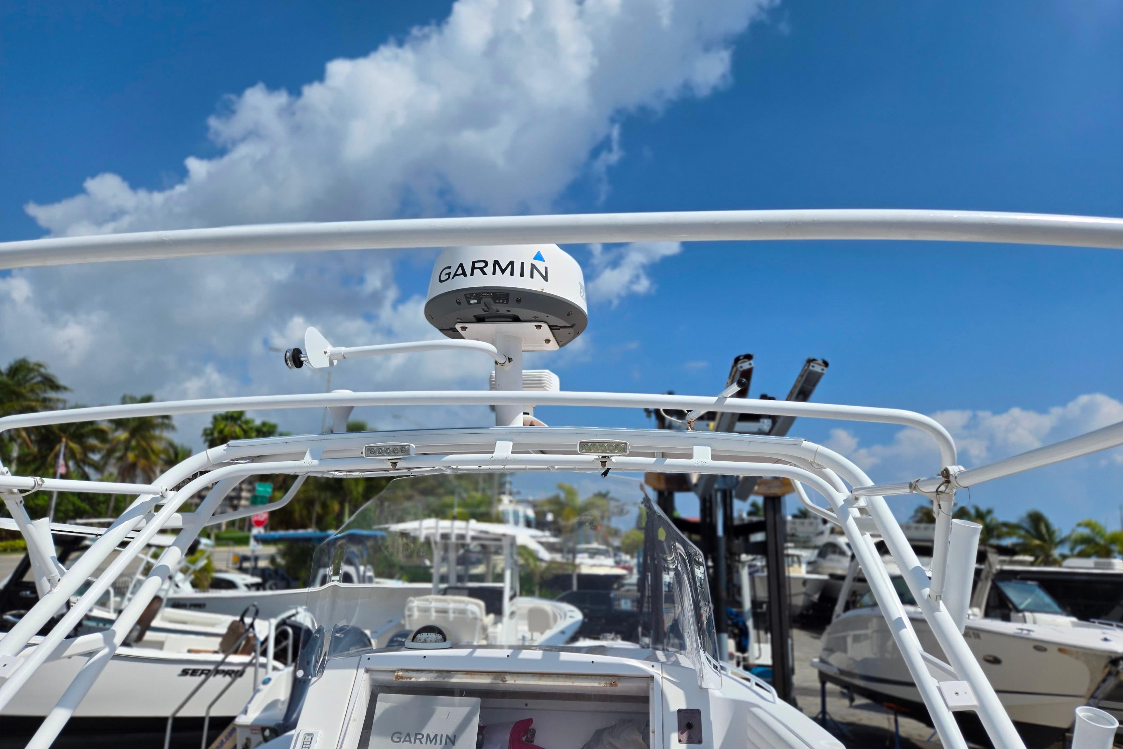 2007 Donzi 35 ZF Daytona boat with Garmin radar, docked under a clear blue sky.