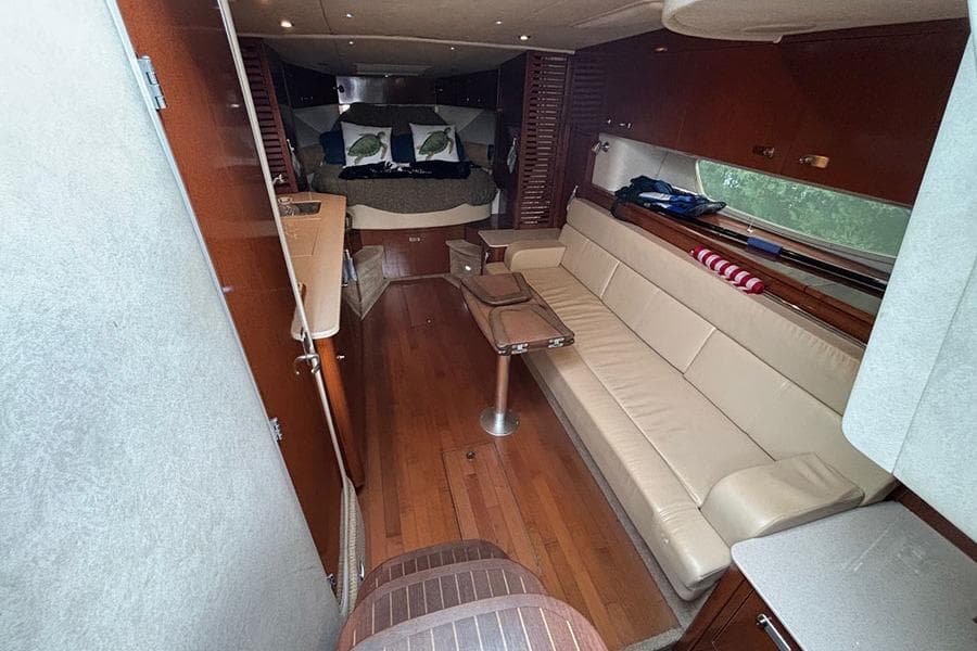 Luxurious interior of 2011 Sea Ray 370 Sundancer with leather seating and wooden flooring.