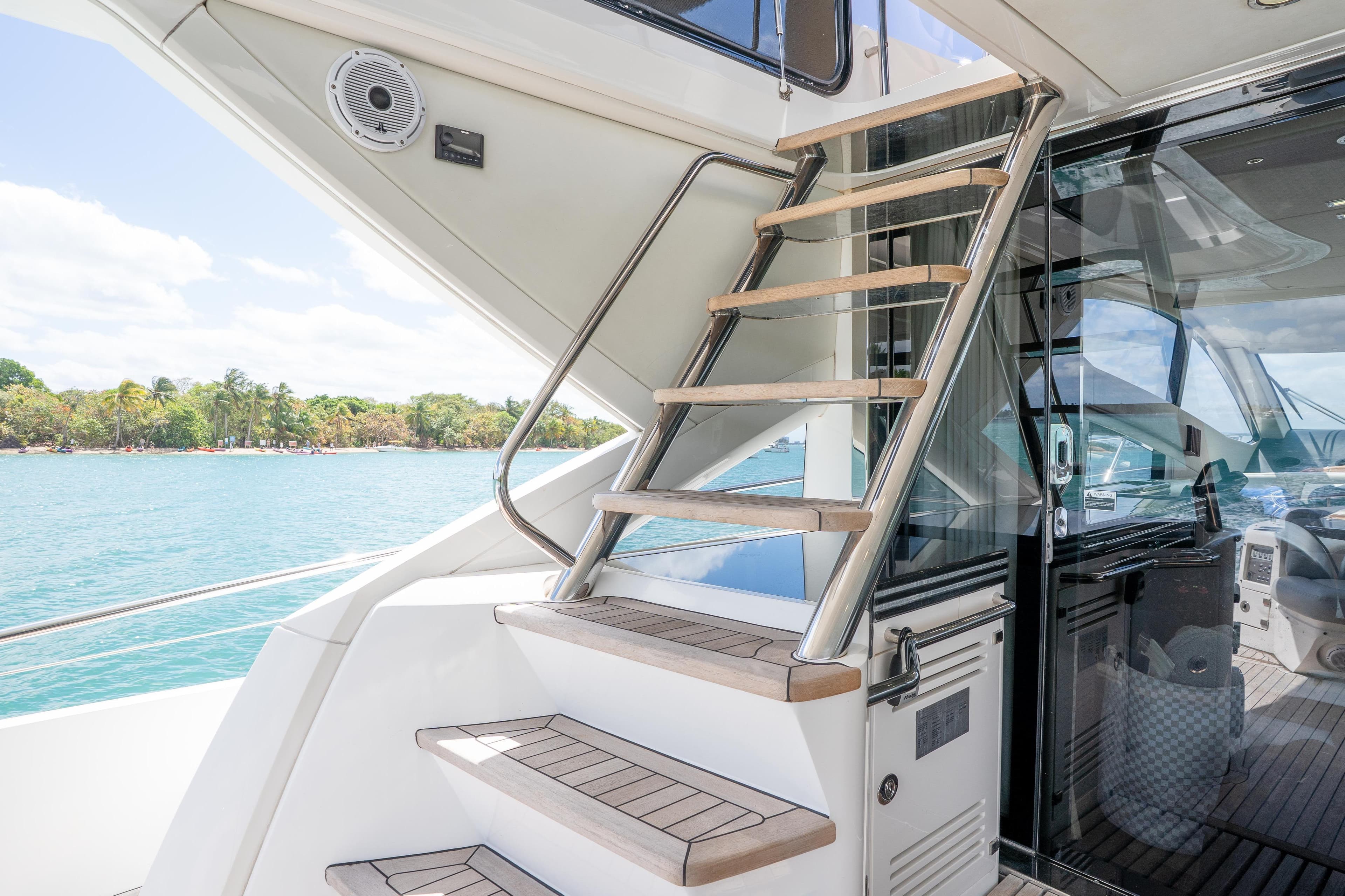 Staircase on 2014 Sunseeker 68 Sport Yacht with ocean view in background.