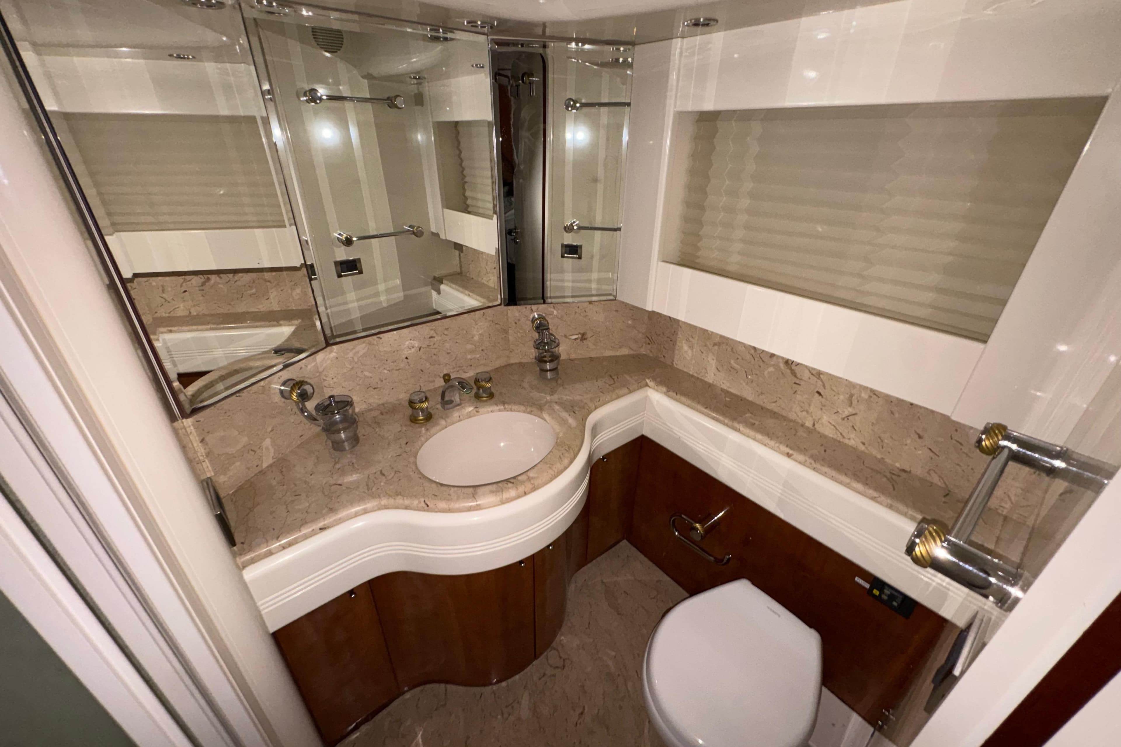 Luxurious bathroom in 1998 Azimut 85 Ultimate yacht with marble countertop and elegant fixtures.