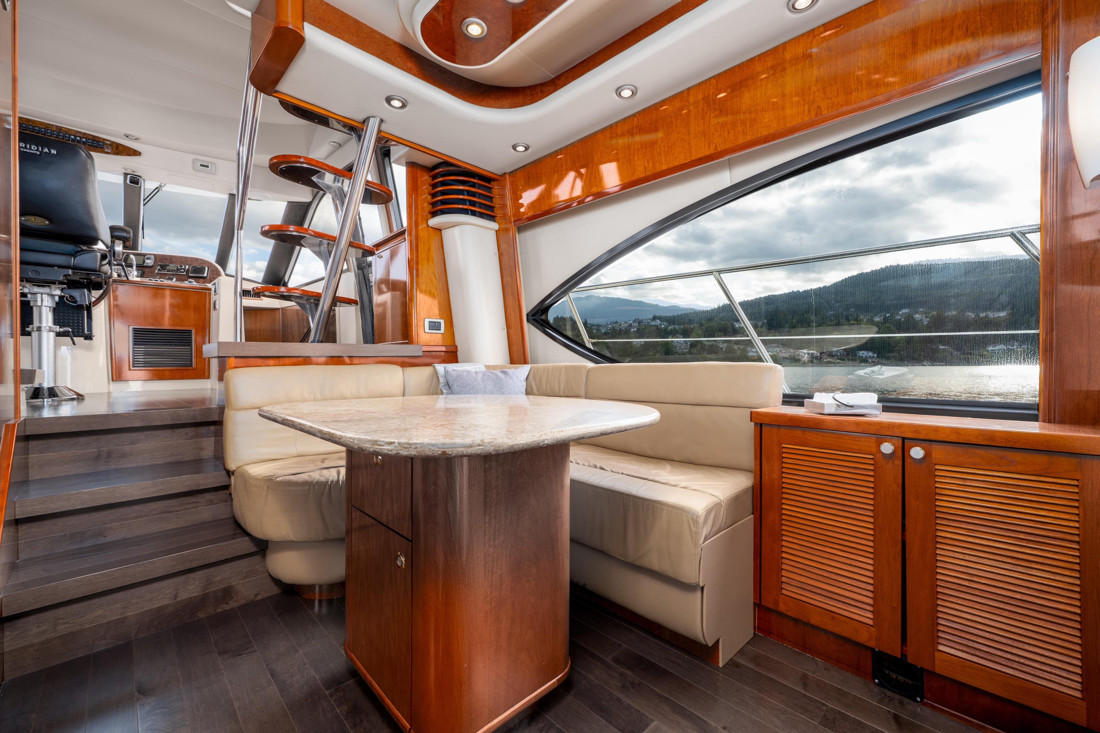 Luxurious 2007 Meridian 580 Pilothouse interior with elegant wood finishes and scenic window views.