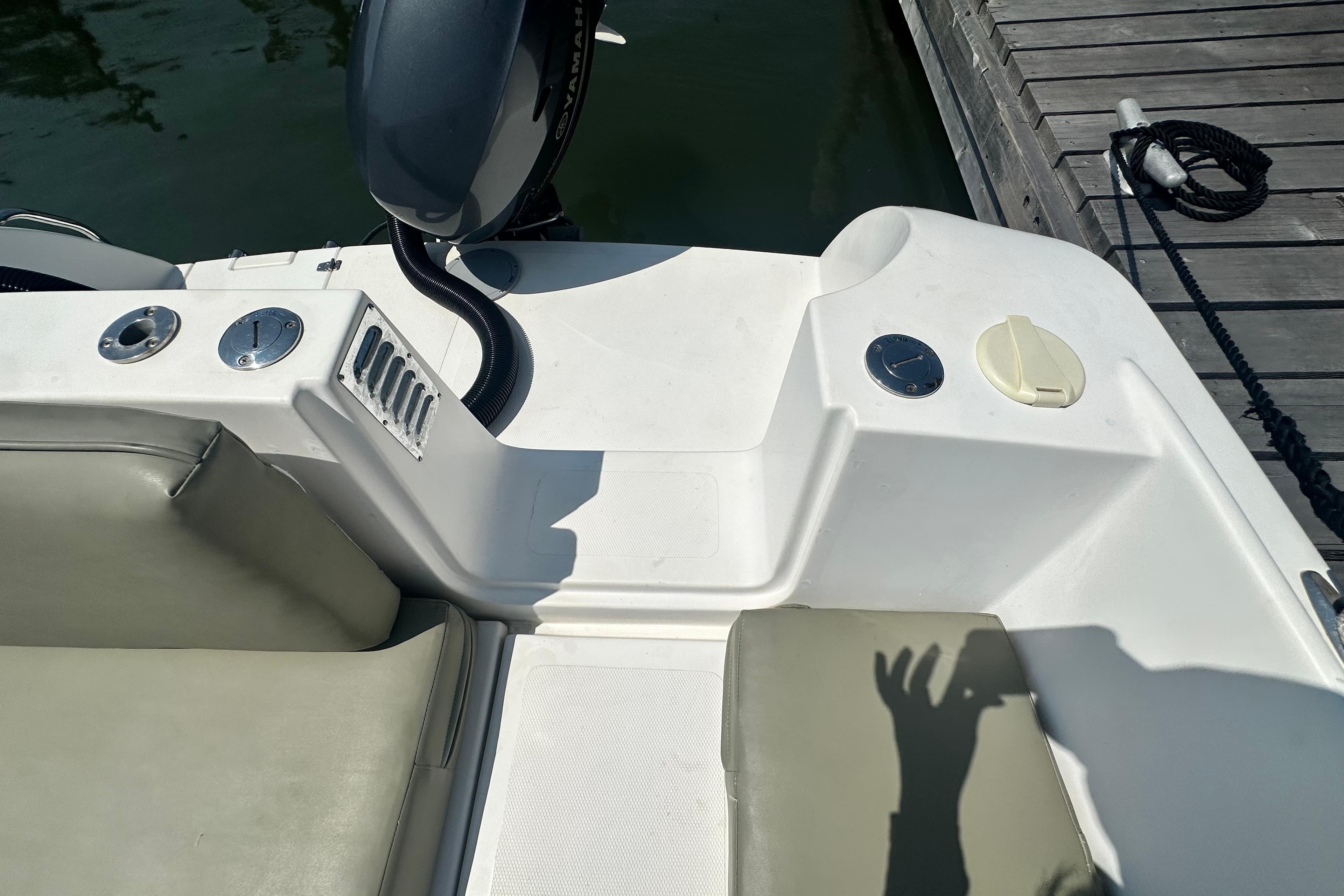 2007 Custom Venet Vision 2 boat interior with seating and engine, docked at marina.