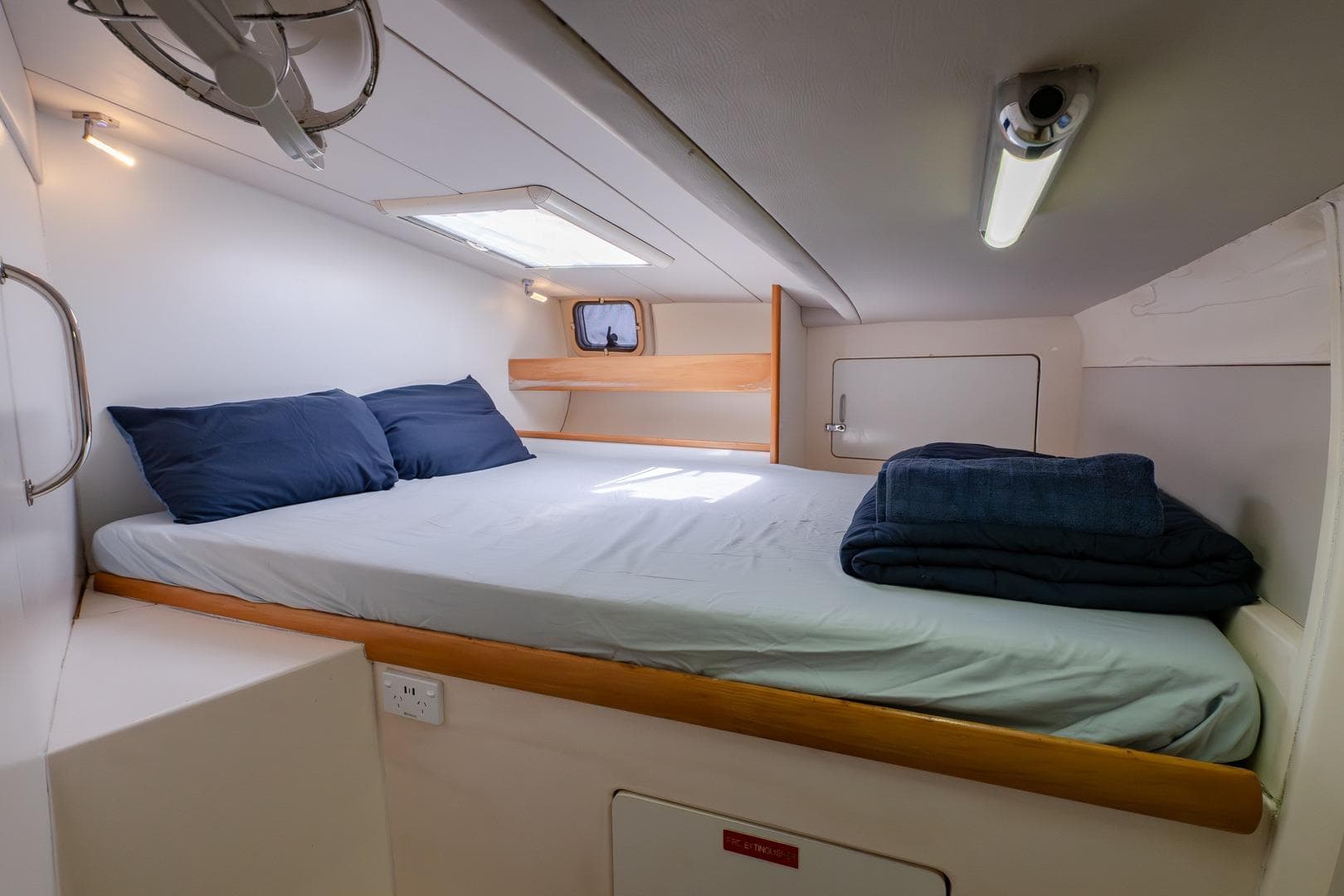 Cozy cabin interior of 2000 Leopard 38 yacht with bed and skylight.