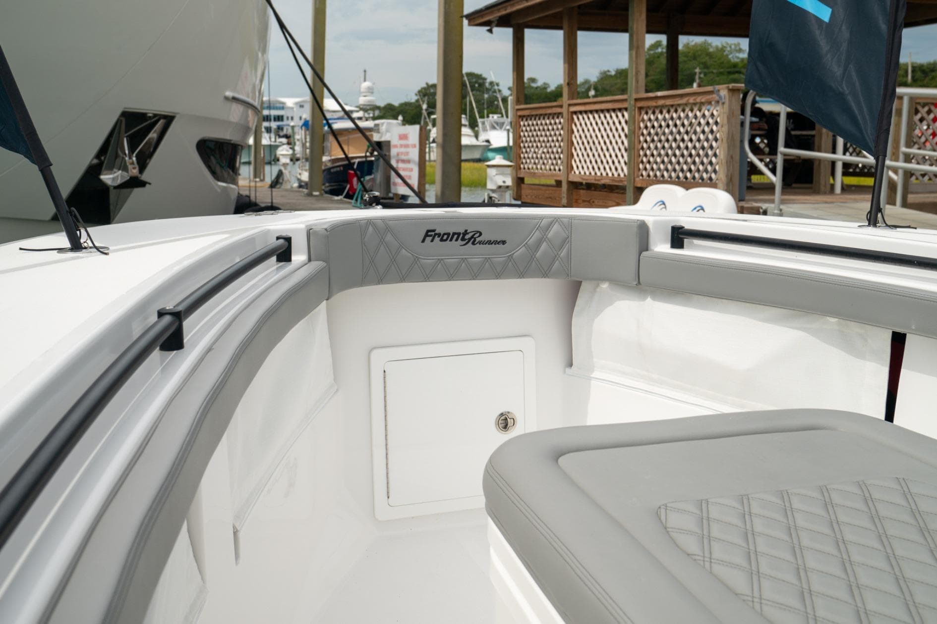 2026 Front Runner 33' Center Console boat interior with cushioned seating and storage.