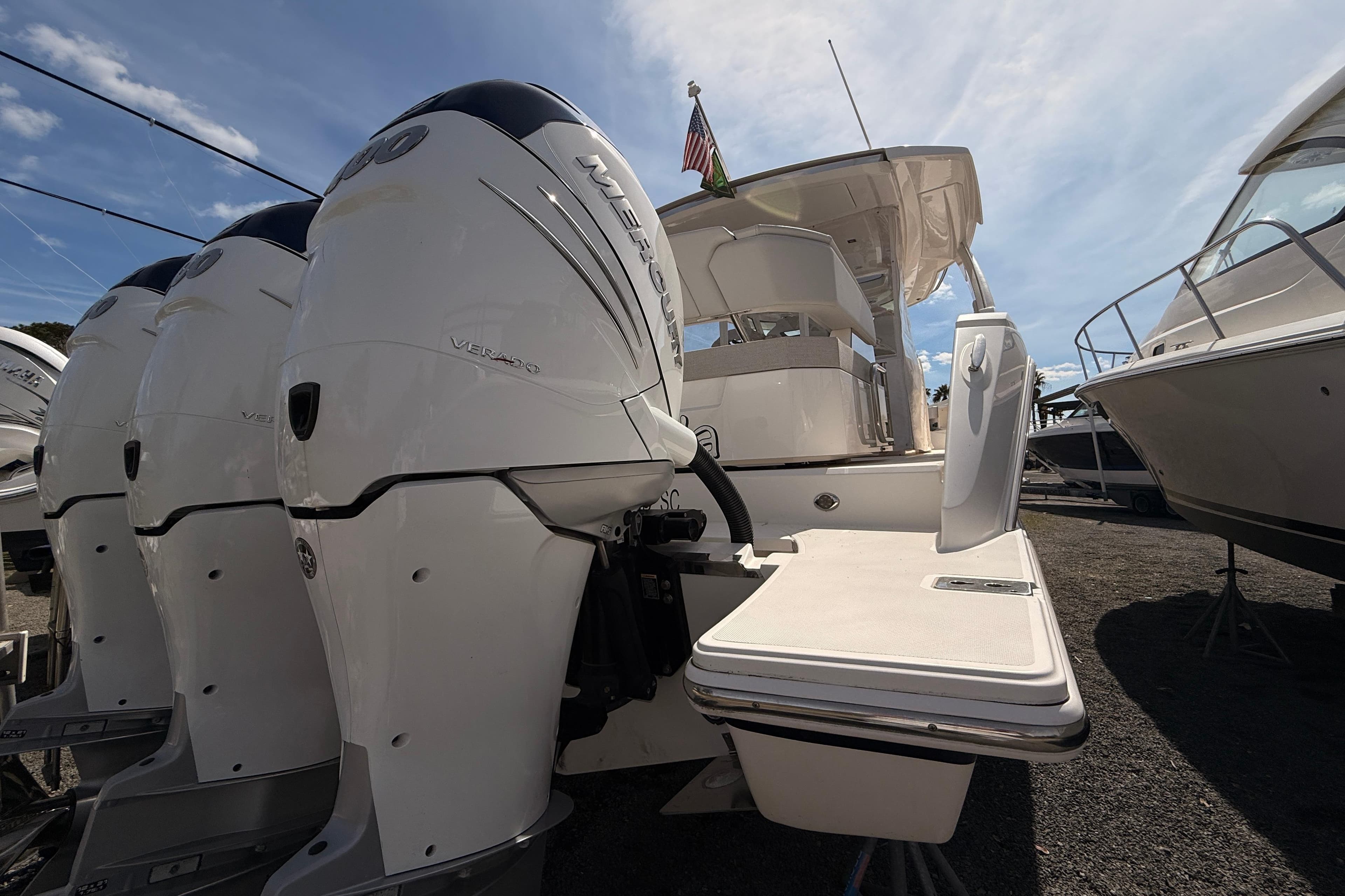 2022 Tiara Yachts 38 LS with powerful outboard engines, docked under a clear sky.