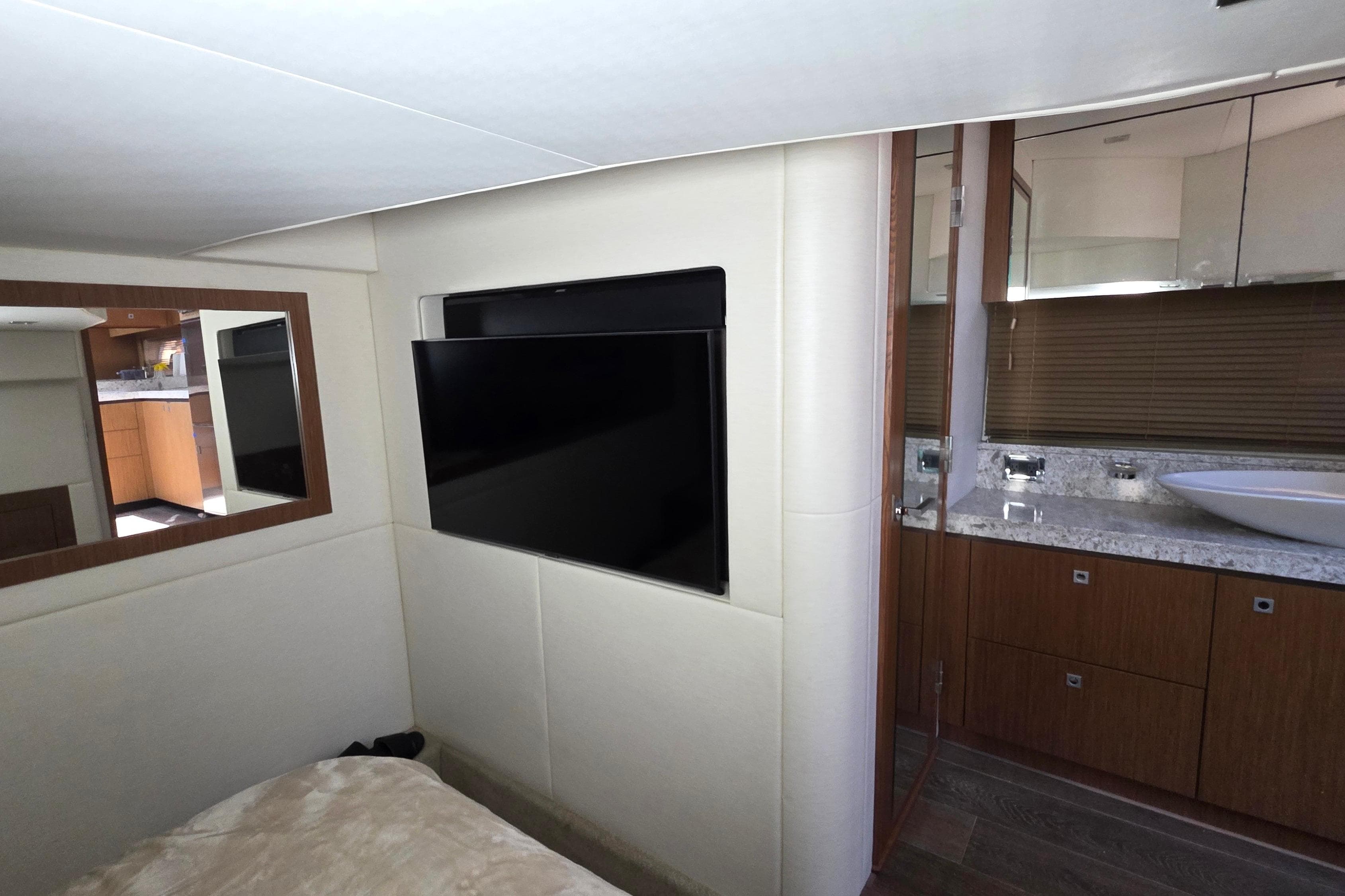 Interior of 2018 Sea Ray Sundancer 510 yacht with TV and modern bathroom.