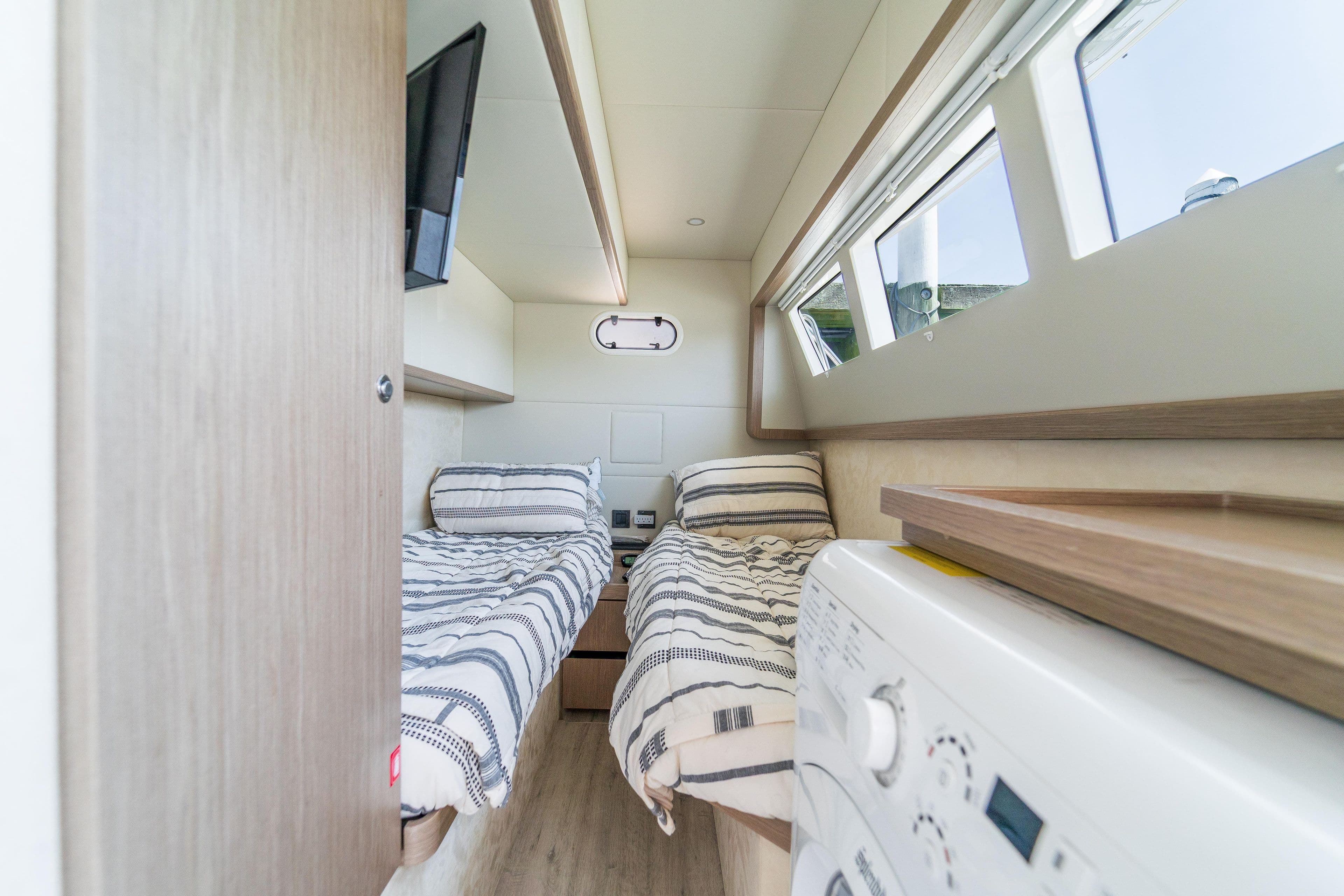 2023 Absolute 62 Fly yacht cabin with twin beds and modern amenities.