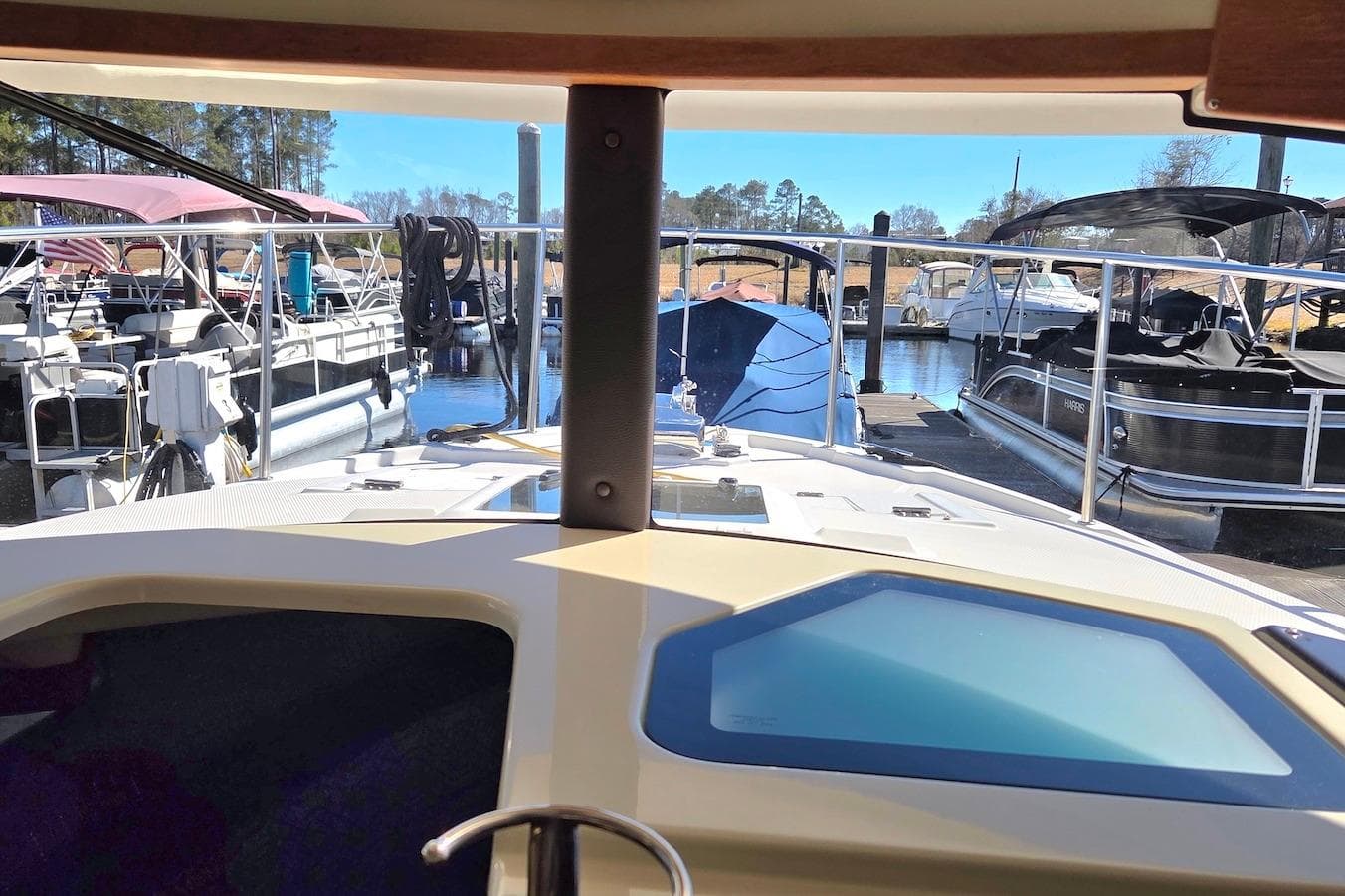 2022 Ranger Tugs R-27 docked at marina, surrounded by other boats.