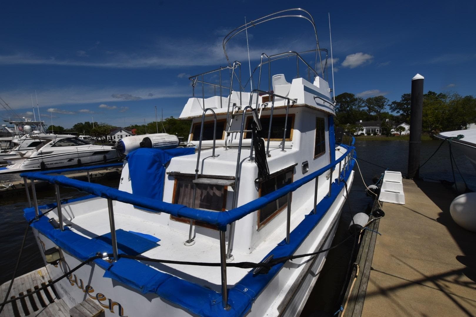 1988 Marine Trader 34 Double Cabin yacht docked at marina under clear blue sky.