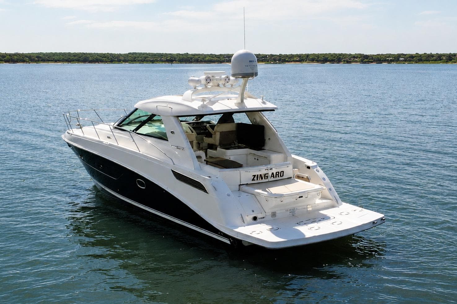 2013 Sea Ray 450 Sundancer yacht on calm water, rear view.