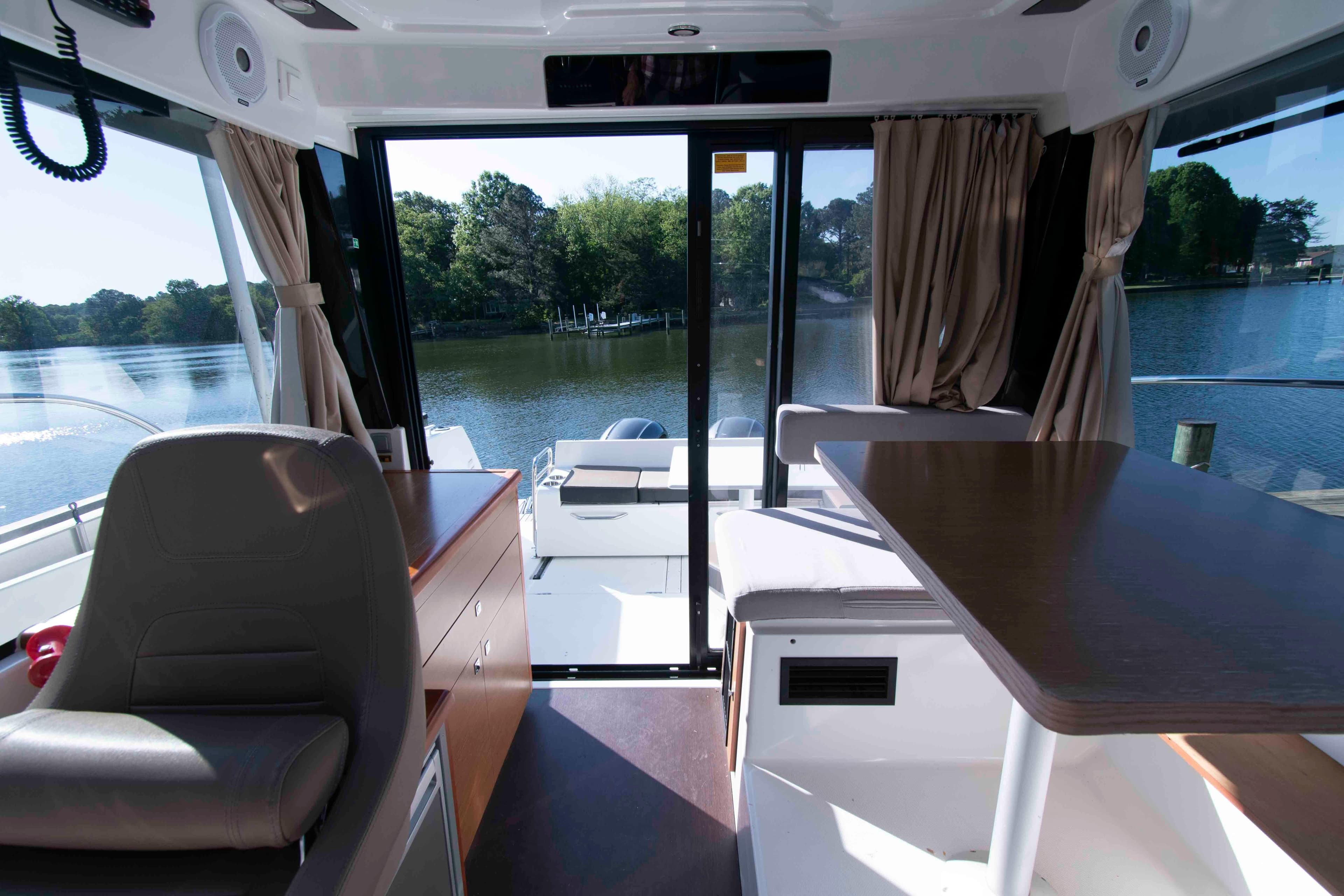 Interior view of 2017 Jeanneau NC 895 boat with seating and water view.