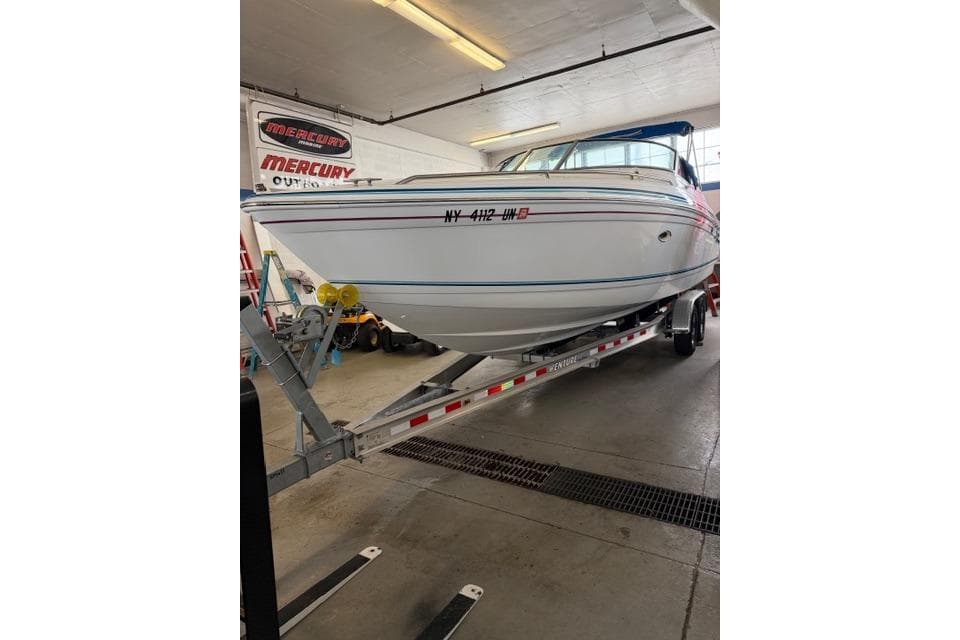 1996 Formula 280 Sun Sport boat on trailer in indoor garage setting.
