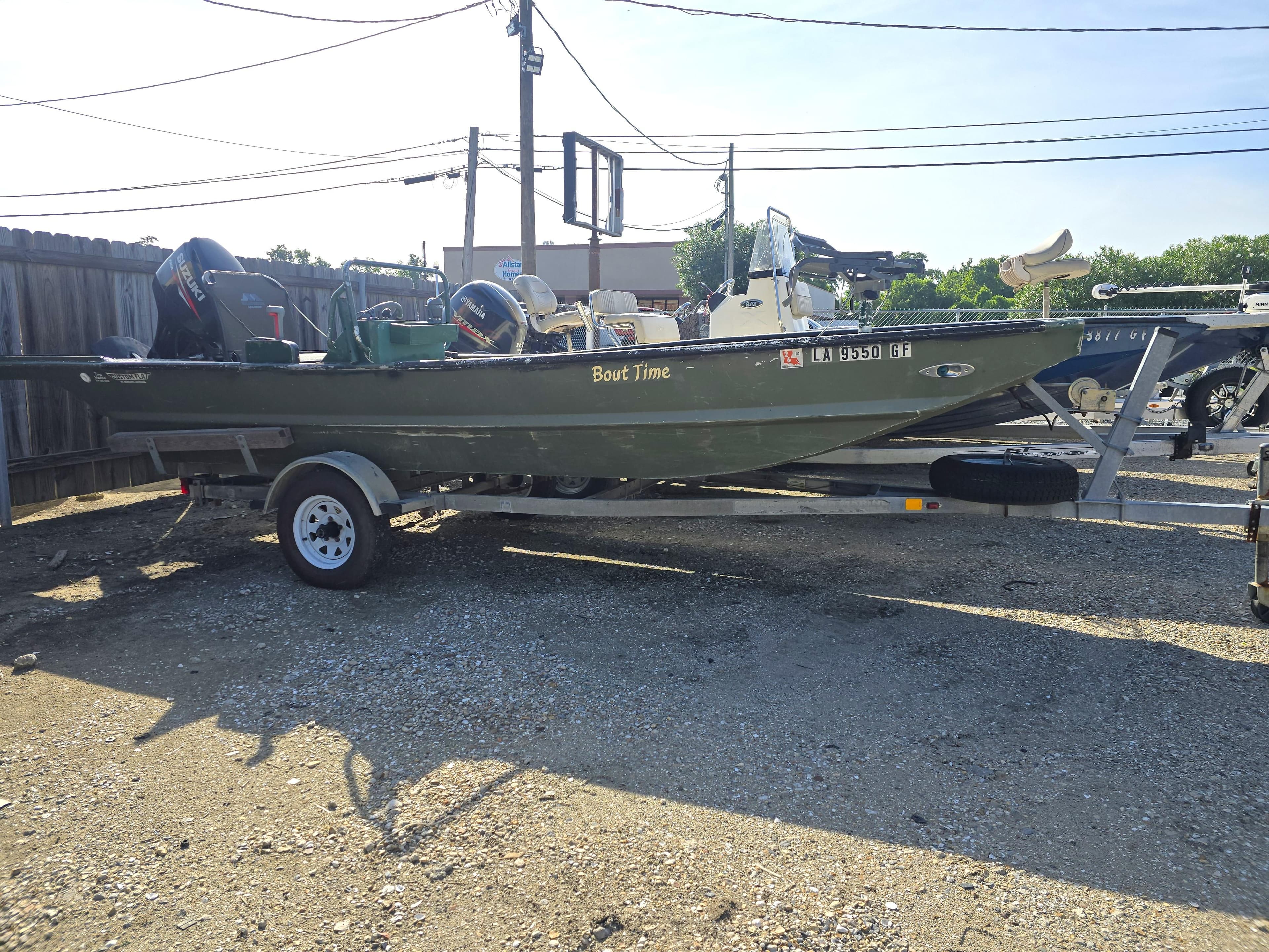 Custom Flat 16 boat on trailer, parked outdoors, labeled "Bout Time," 2016 model.