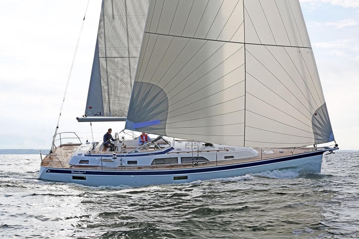2021 Hallberg-Rassy 44 sailboat navigating open waters with full sails.