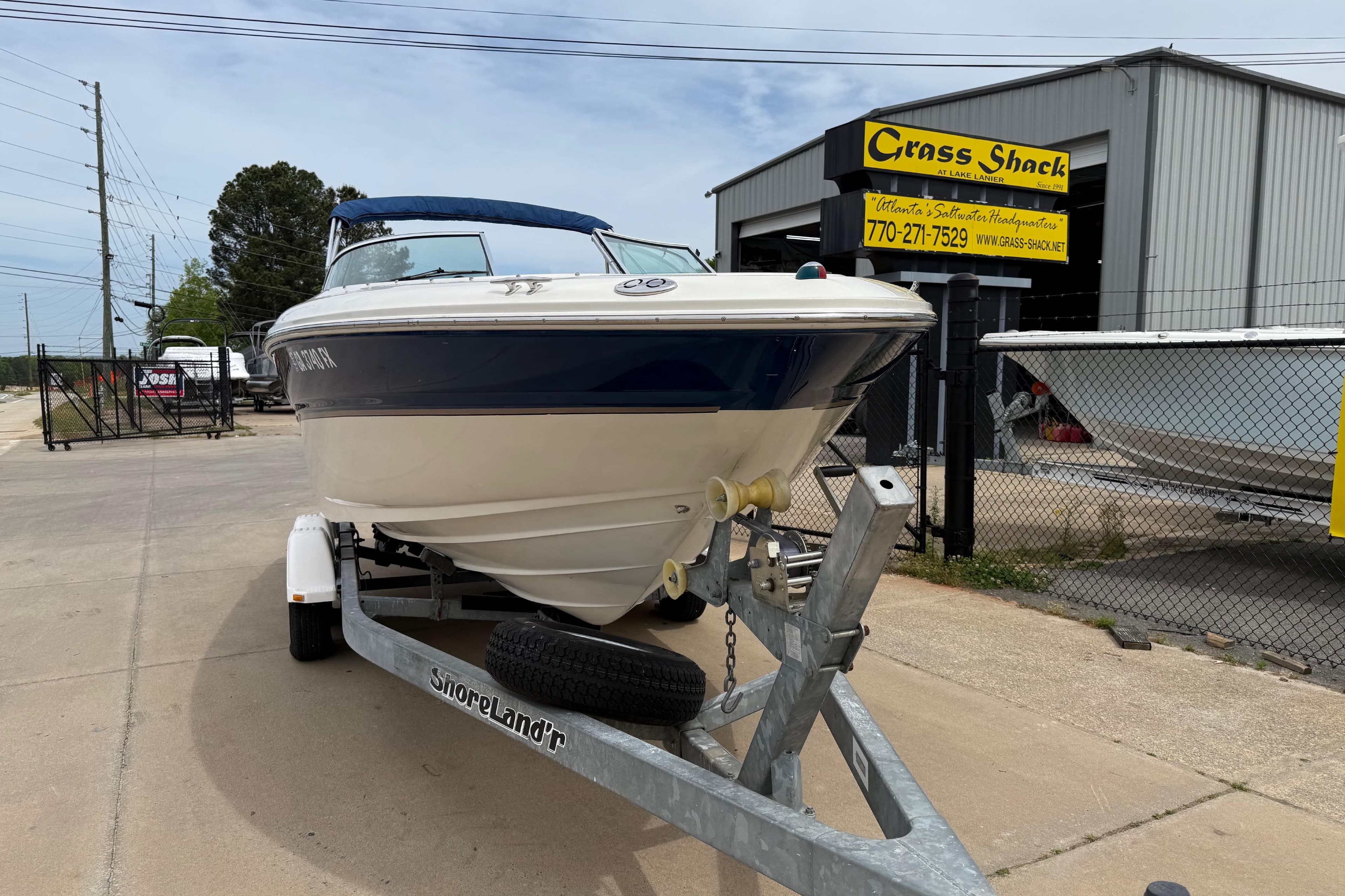 2003 Sea Ray 240 Bow Rider on trailer at Grass Shack dealership.