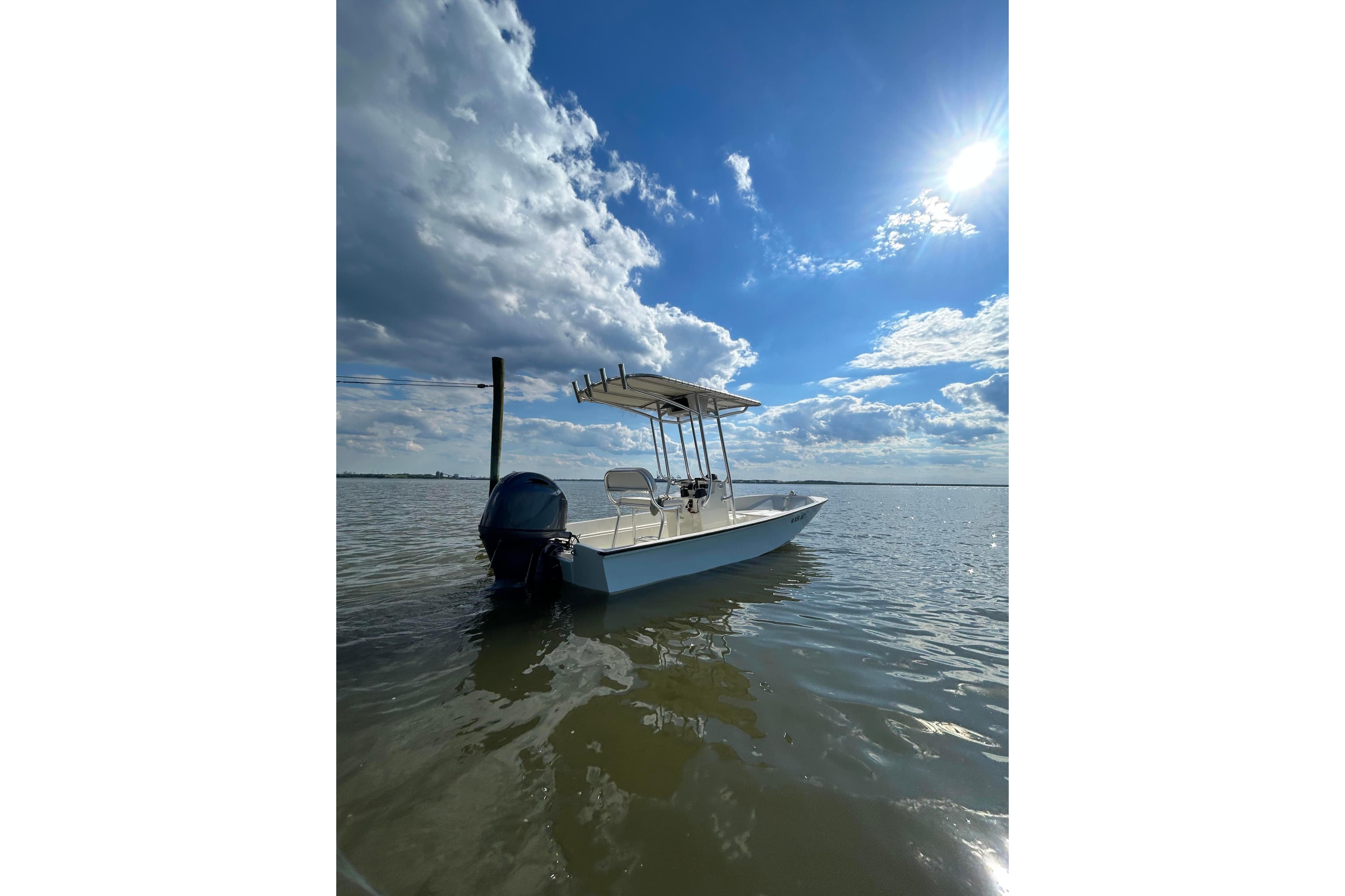 1978 Boston Whaler 17 Montauk boat on calm water under a bright blue sky.