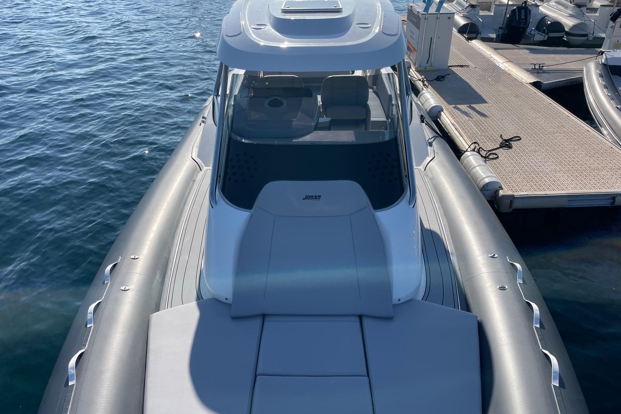 2025 Joker Boat Clubman 35 docked, showcasing sleek design and spacious deck.